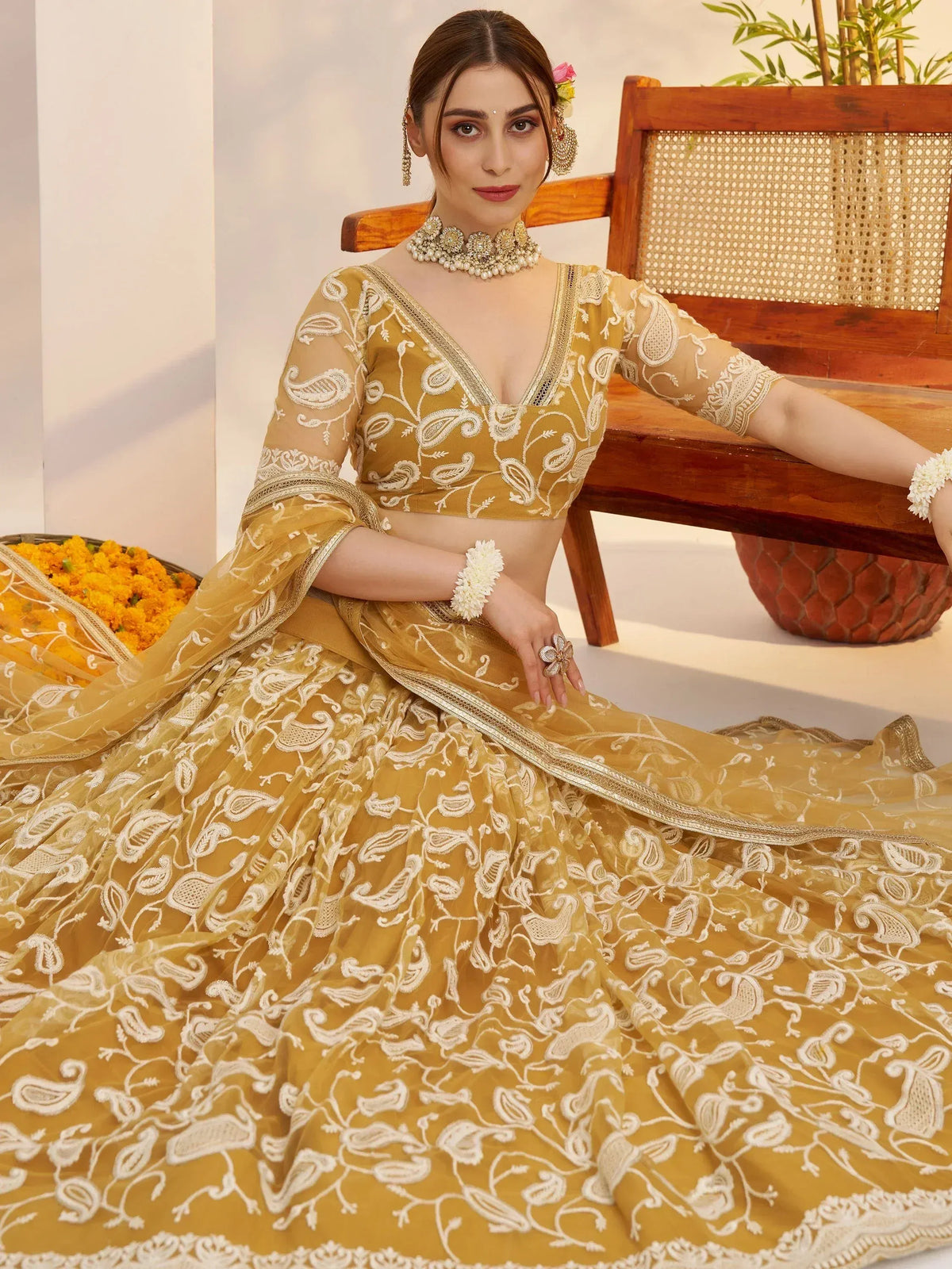 Elegant mustard yellow lehenga choli with white paisley embroidery, perfect for Indian ethnic wear.