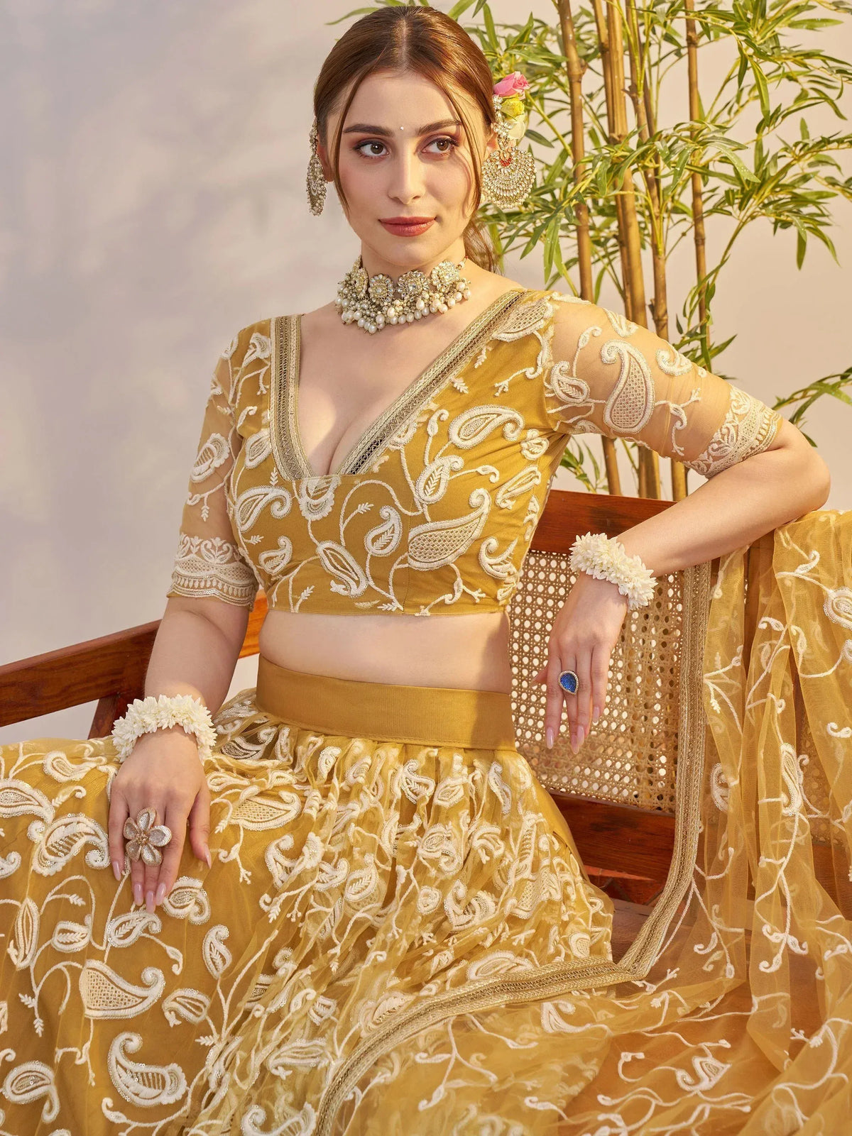 Elegant mustard yellow lehenga choli with white paisley embroidery, perfect for Indian ethnic wear occasions.