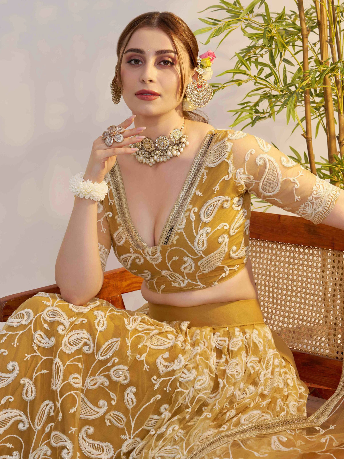Elegant mustard yellow lehenga choli with white paisley embroidery, perfect for Indian ethnic wear occasions.