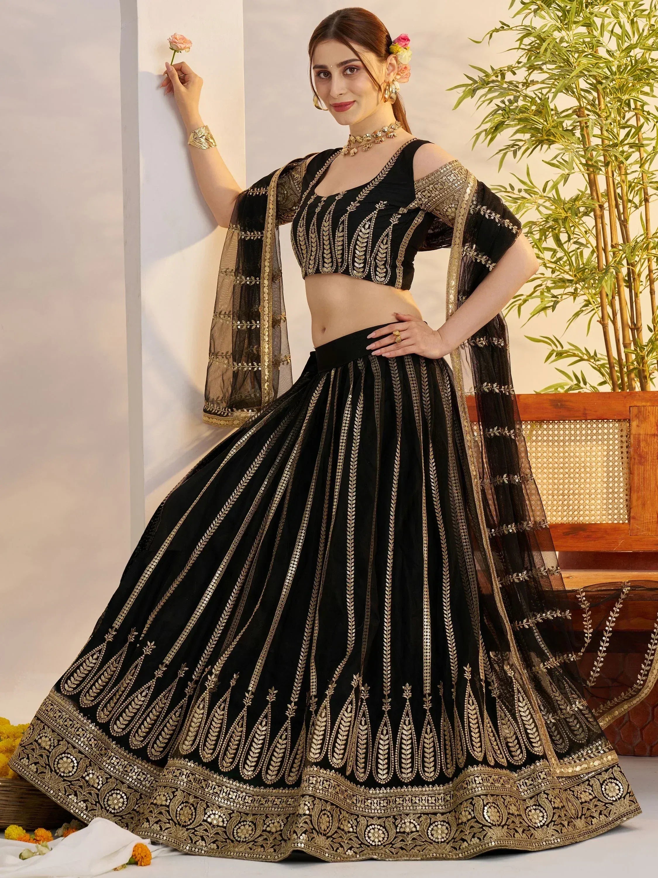 Black and gold embroidered lehenga choli with sheer dupatta, perfect for Indian ethnic occasions