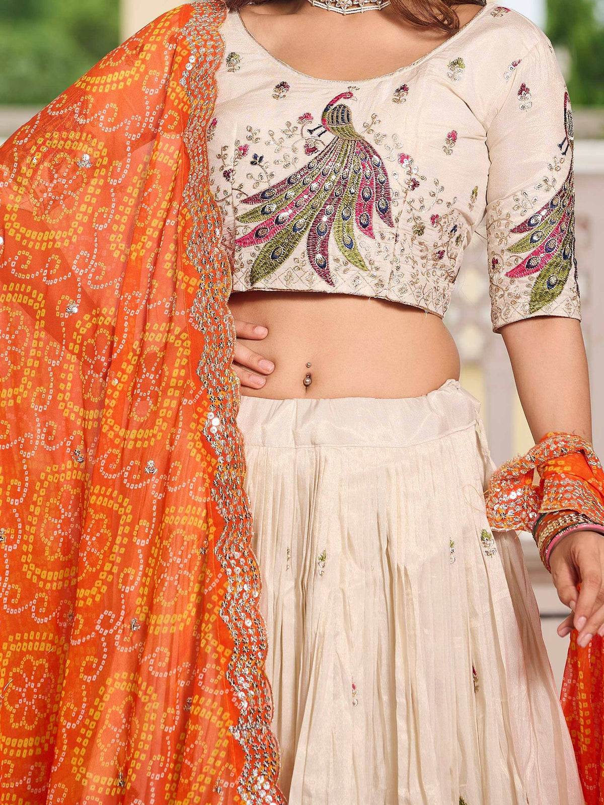Cream peacock-embroidered lehenga choli with orange dupatta, Indian ethnic wear