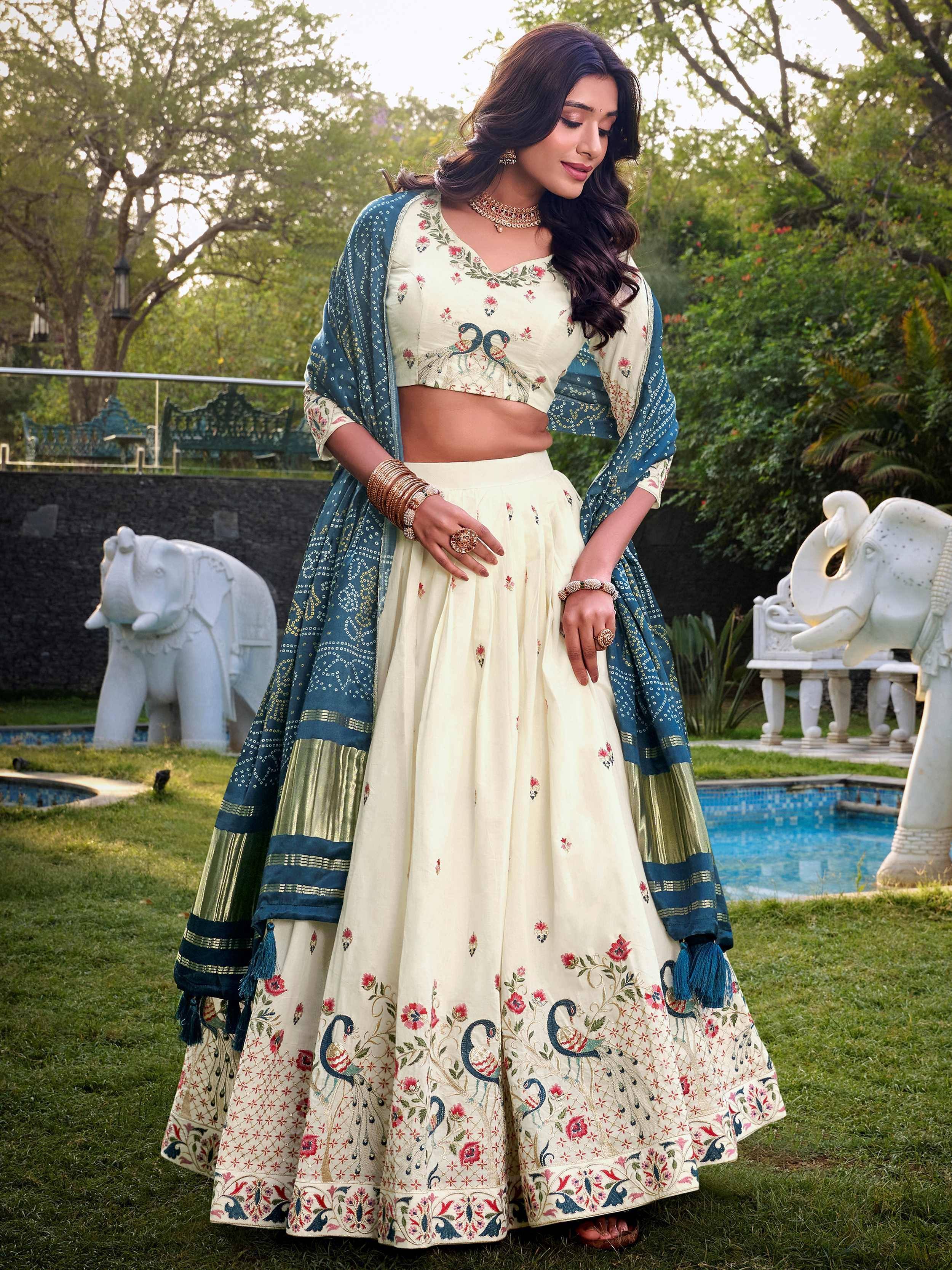 Cream floral embroidered lehenga choli with blue dupatta, perfect for Indian ethnic wear occasions