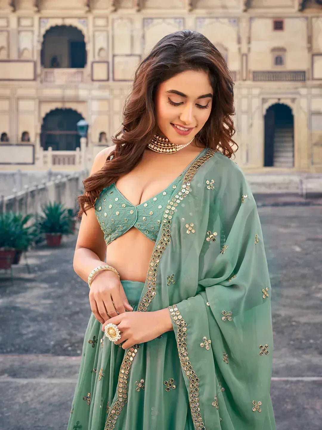 Mint green designer lehenga choli with gold mirror work, perfect for Indian ethnic wear occasions
