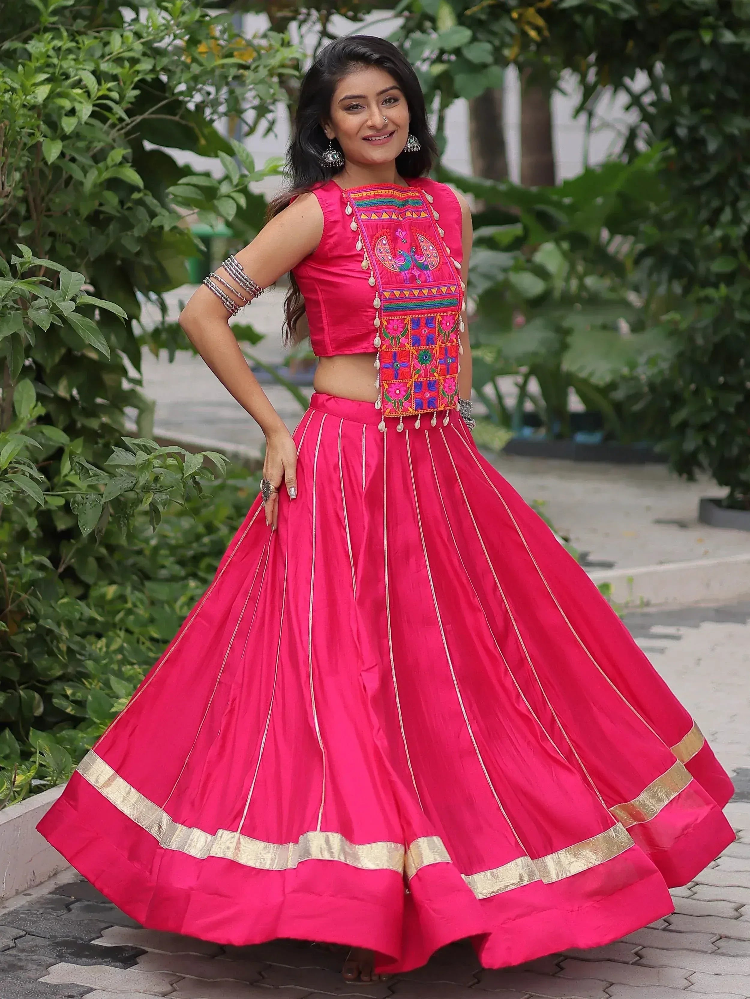 Pink embroidered lehenga choli with peacock motifs, gold border, and flared skirt for Indian ethnic wear