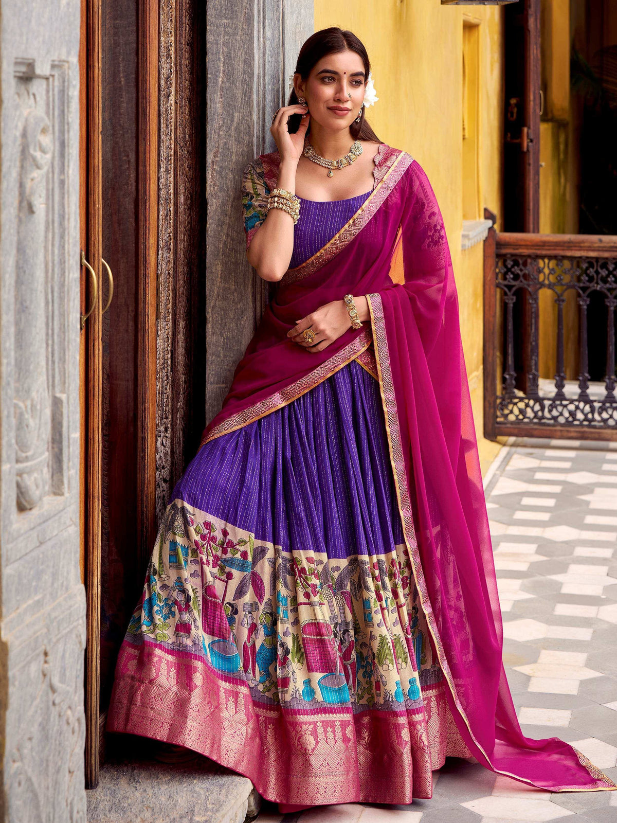 Purple and magenta printed lehenga choli with ethnic motifs, perfect for Indian weddings and festive occasions.