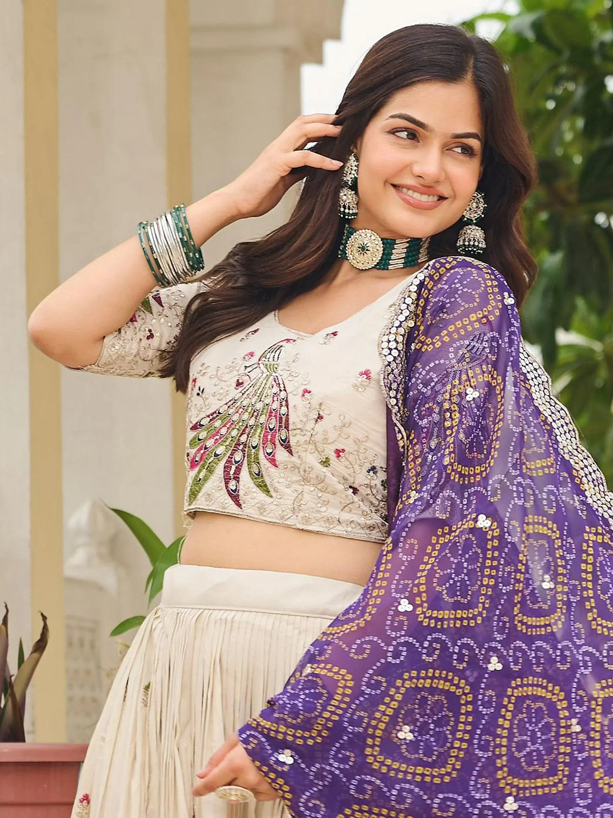 Woman in embroidered peacock blouse with purple sequin dupatta, Indian ethnic wear