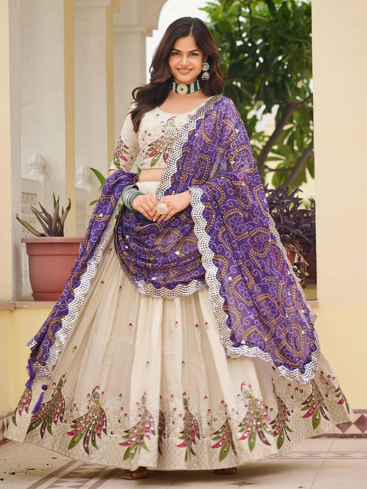 Elegant ivory lehenga choli with peacock embroidery and purple sequin dupatta for Indian ethnic wear