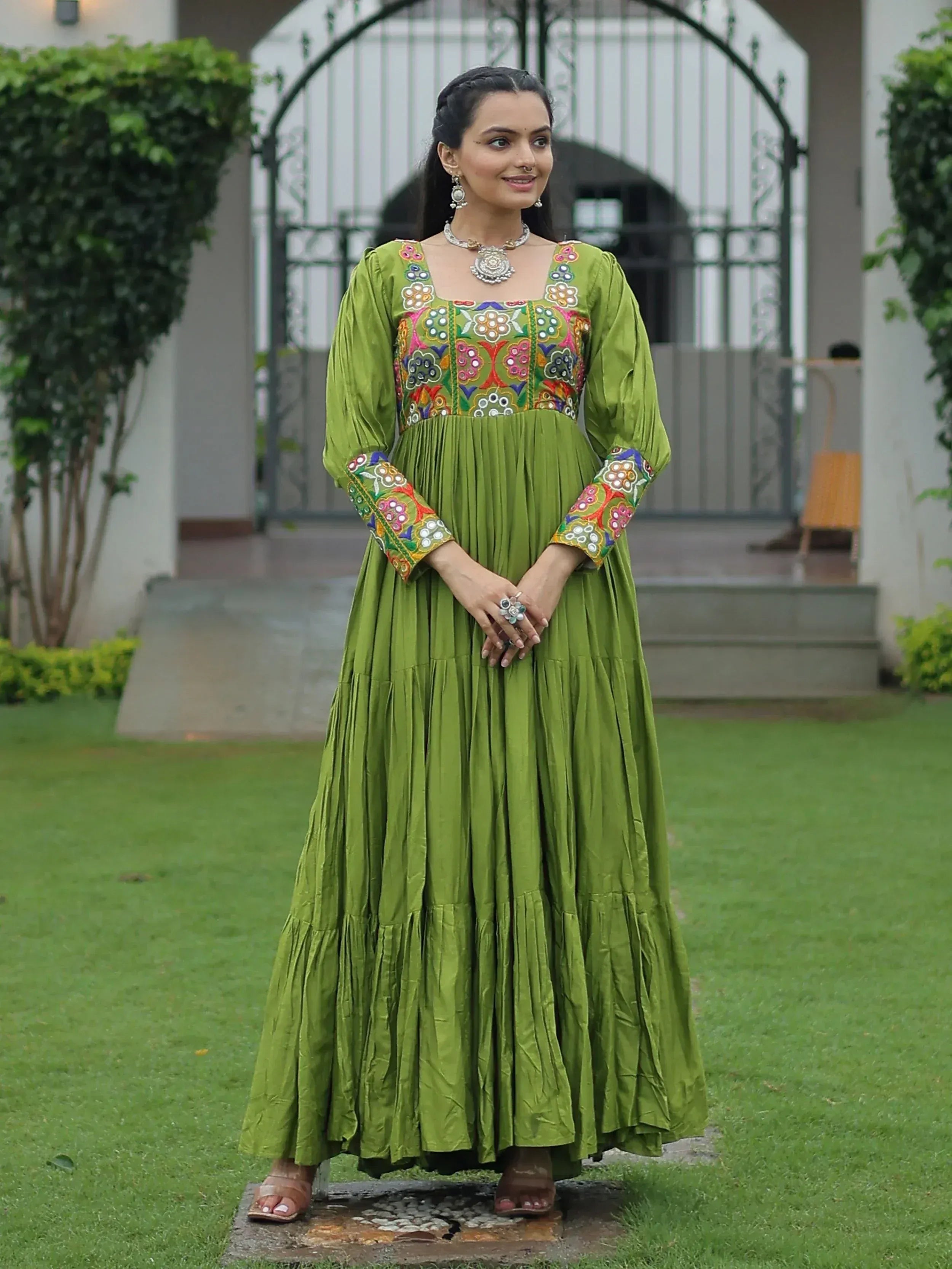 Green embroidered ethnic gown with floral motifs, perfect for Indian festive occasions and weddings.