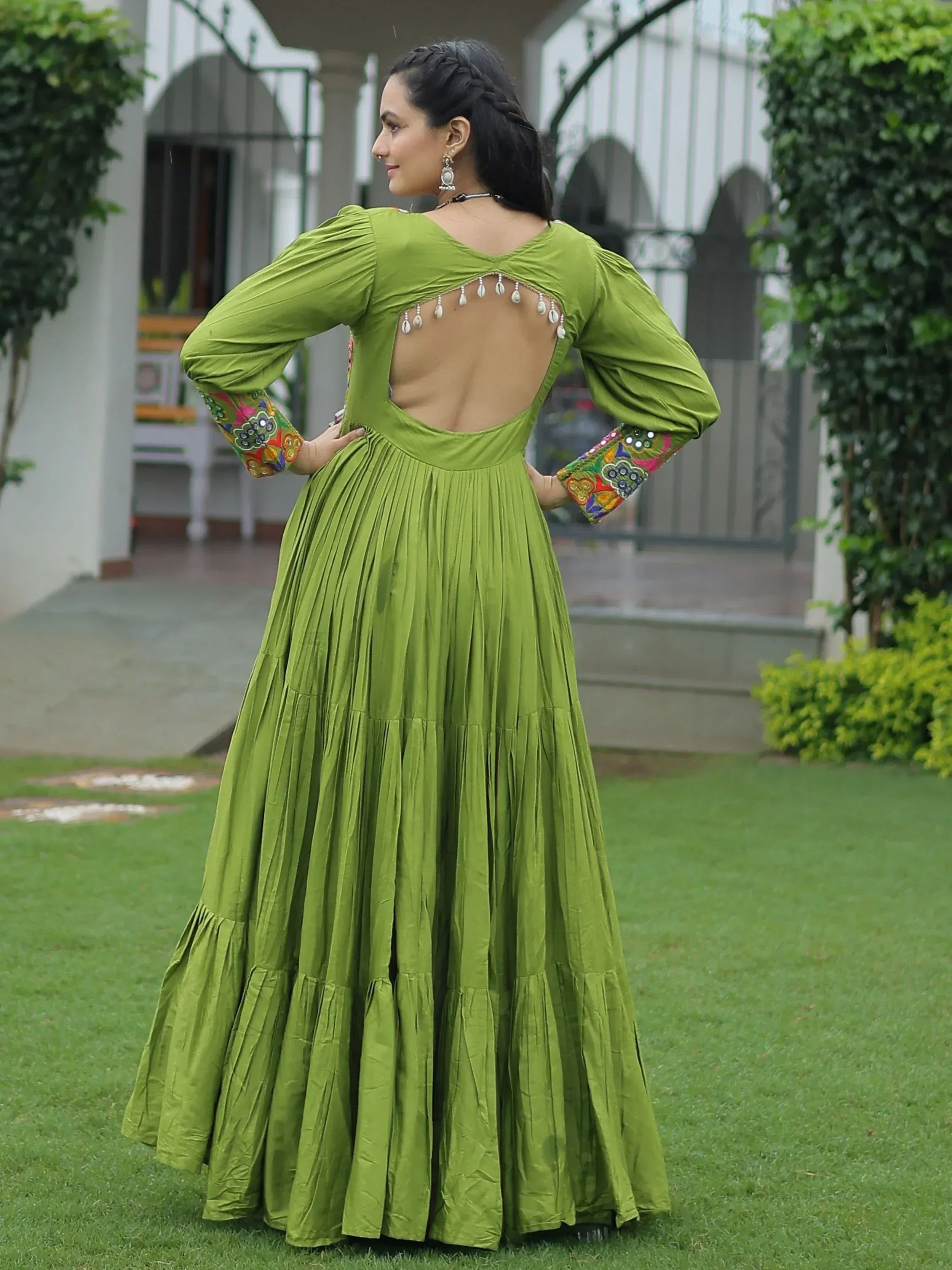 Green ethnic gown with back cutout and embroidered sleeves, perfect for Indian occasions