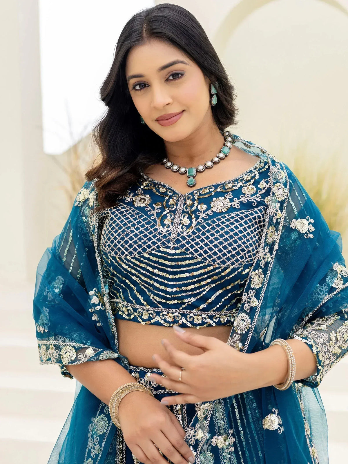 Teal blue embroidered lehenga choli with gold detailing, perfect for Indian ethnic wear occasions