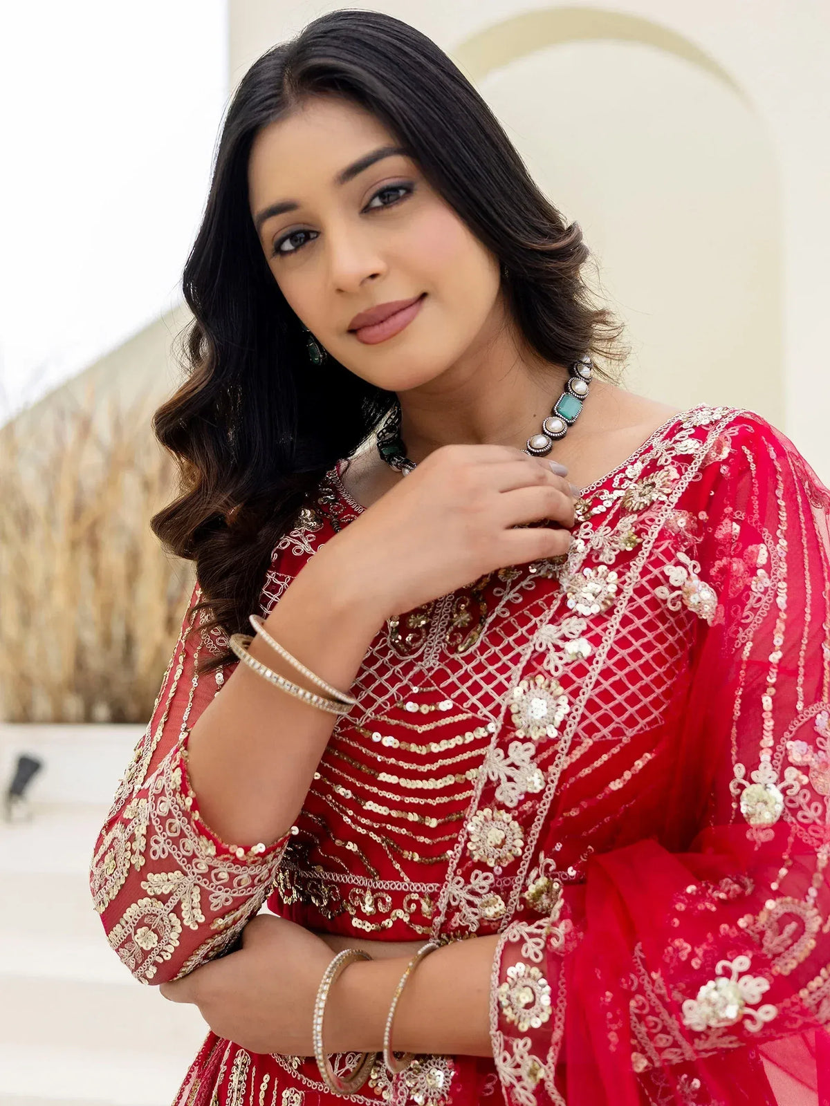 Red embroidered Indian ethnic gown with gold sequin detailing, perfect for festive occasions and weddings.
