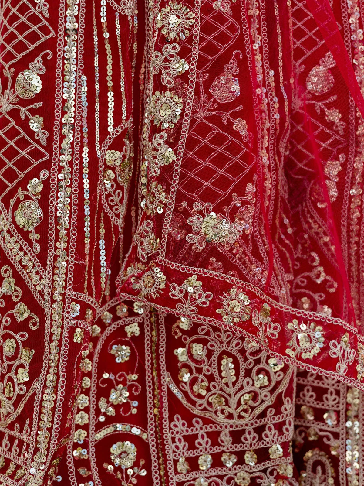 Red ethnic gown with gold sequin embroidery and floral patterns, perfect for Indian weddings or festive occasions.