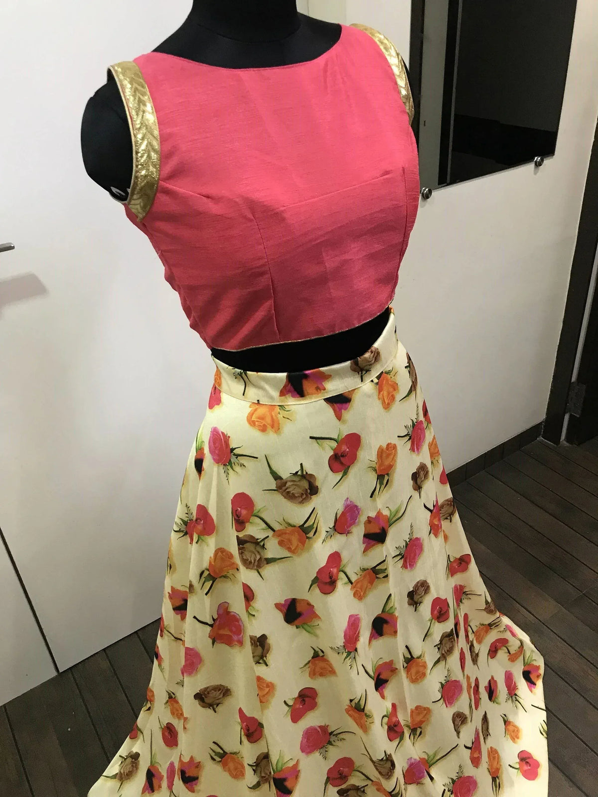 Pink sleeveless top with gold trim paired with floral print skirt, Indian ethnic wear
