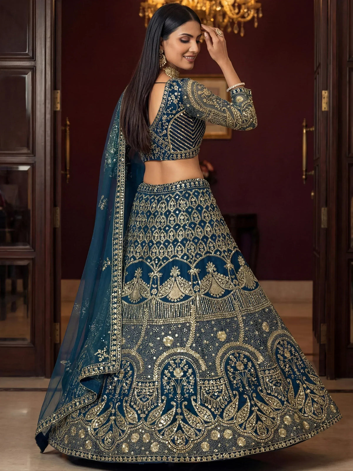 Elegant navy blue lehenga choli with intricate gold embroidery, perfect for Indian weddings and festive occasions.