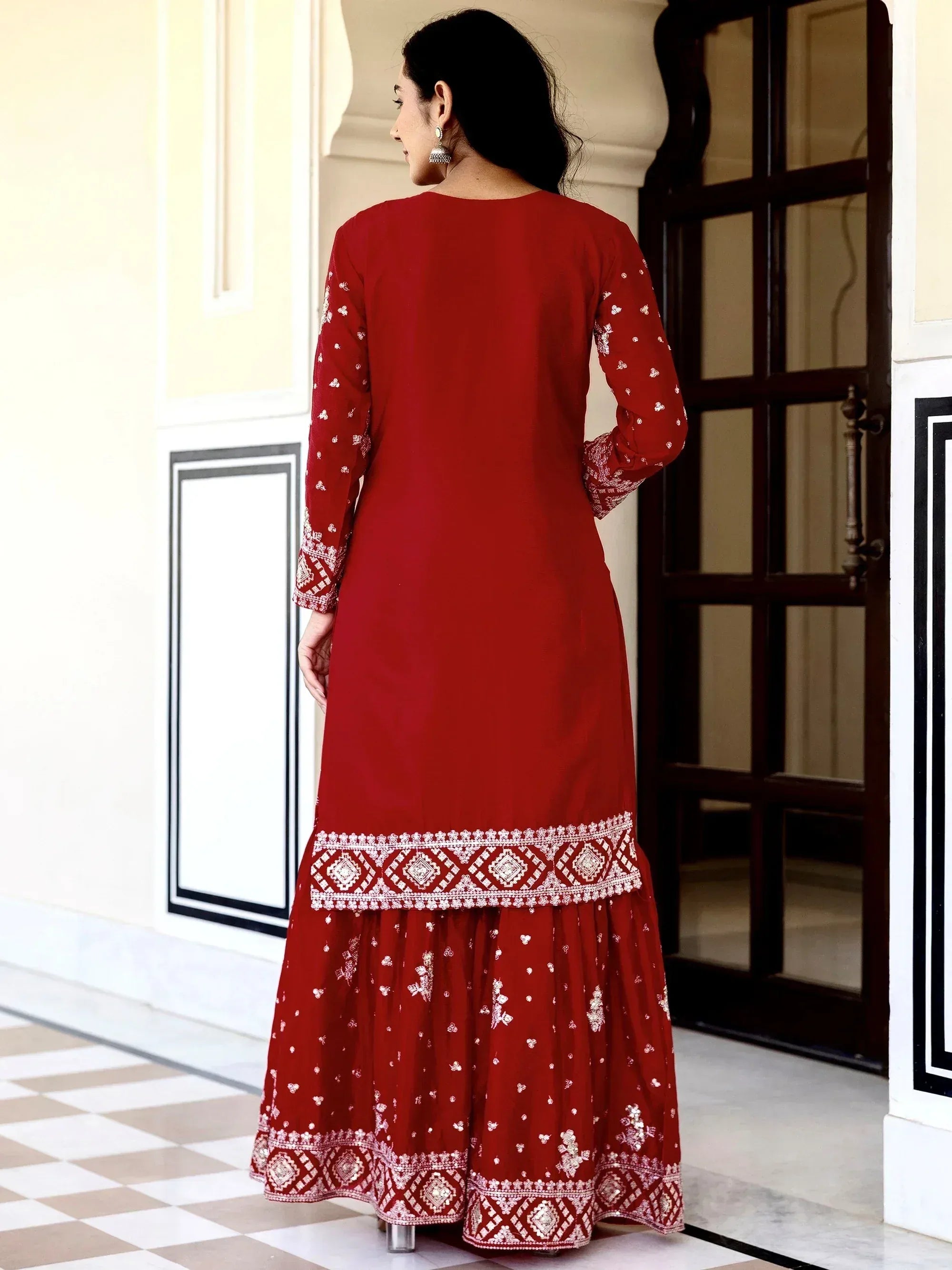 Red embroidered ethnic gown with white detailing, perfect for festive occasions