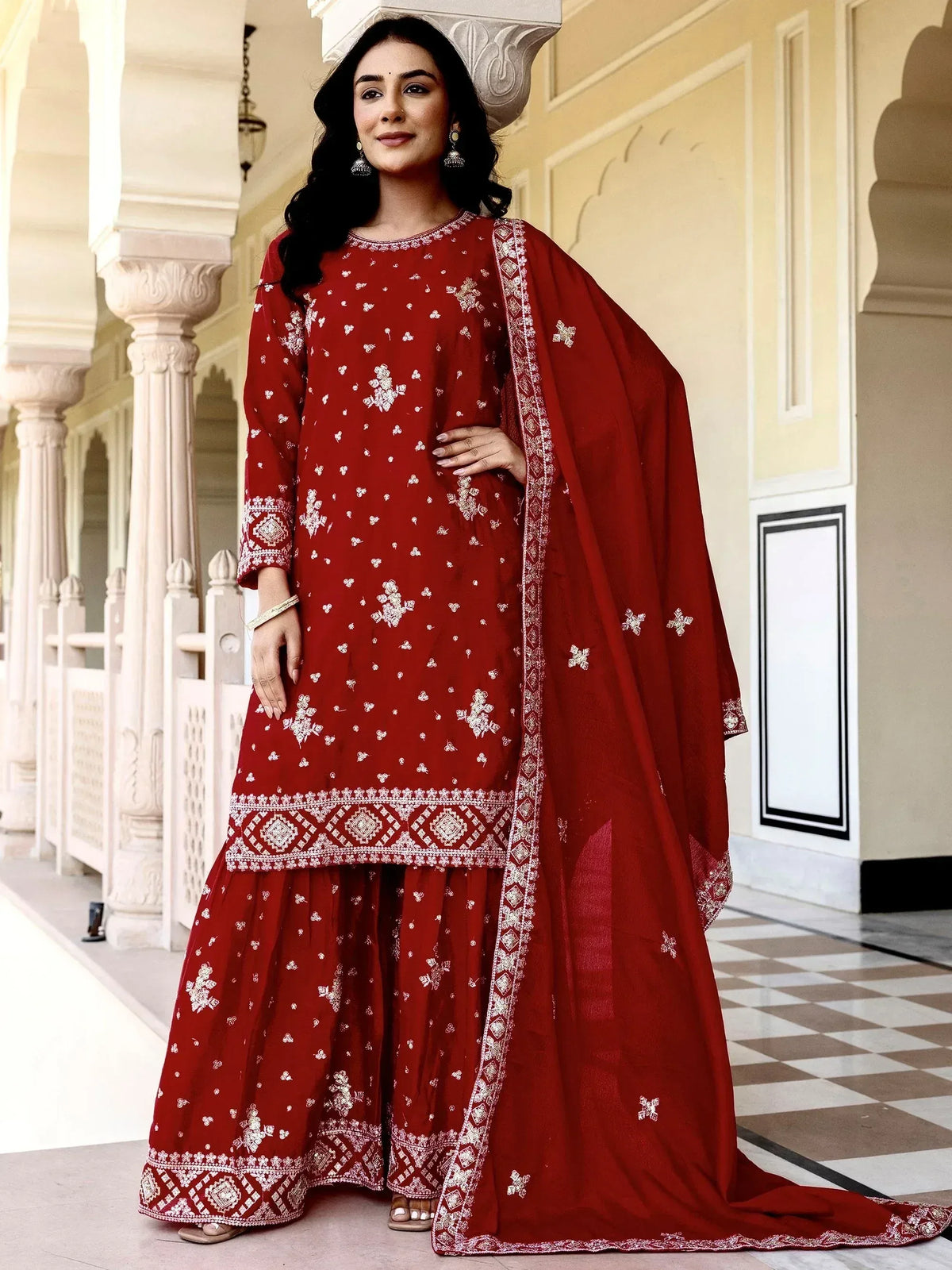 Red embroidered salwar kameez with floral patterns and matching dupatta for ethnic wear