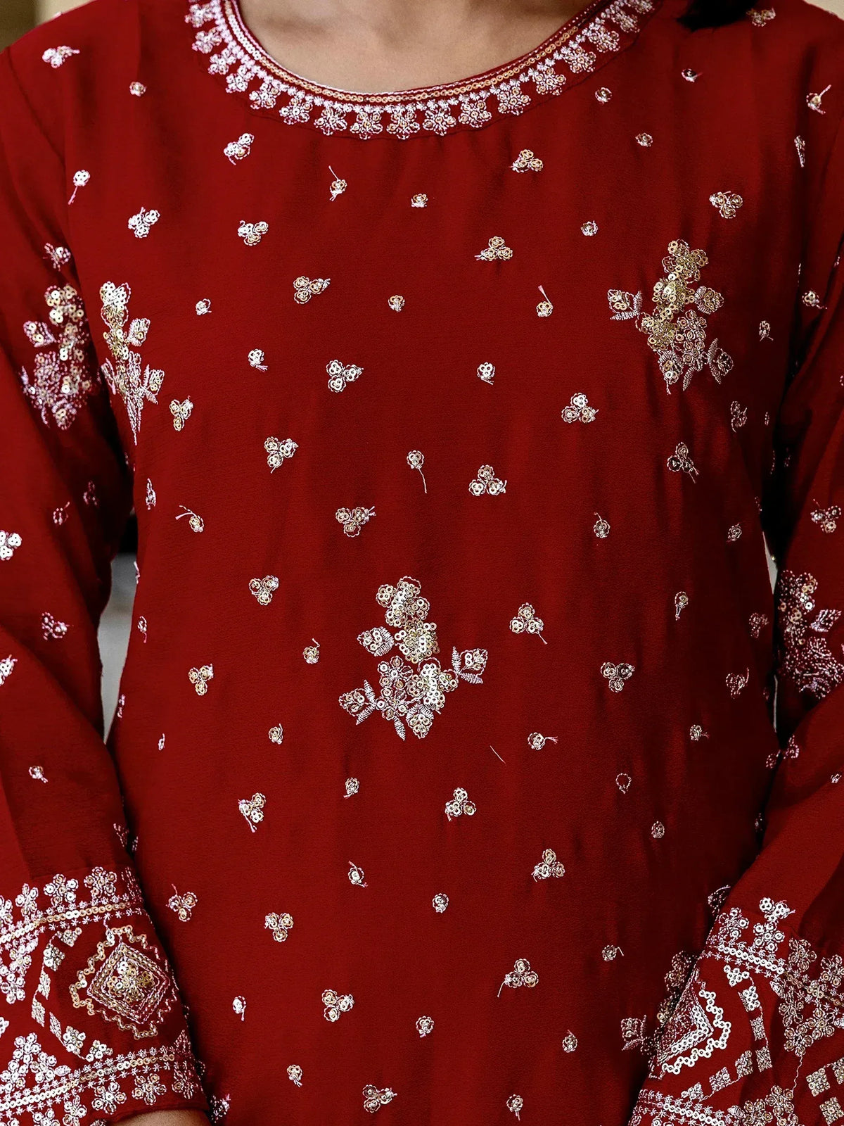 Red ethnic kurti with floral sequin embroidery and detailed neckline, perfect for festive occasions.