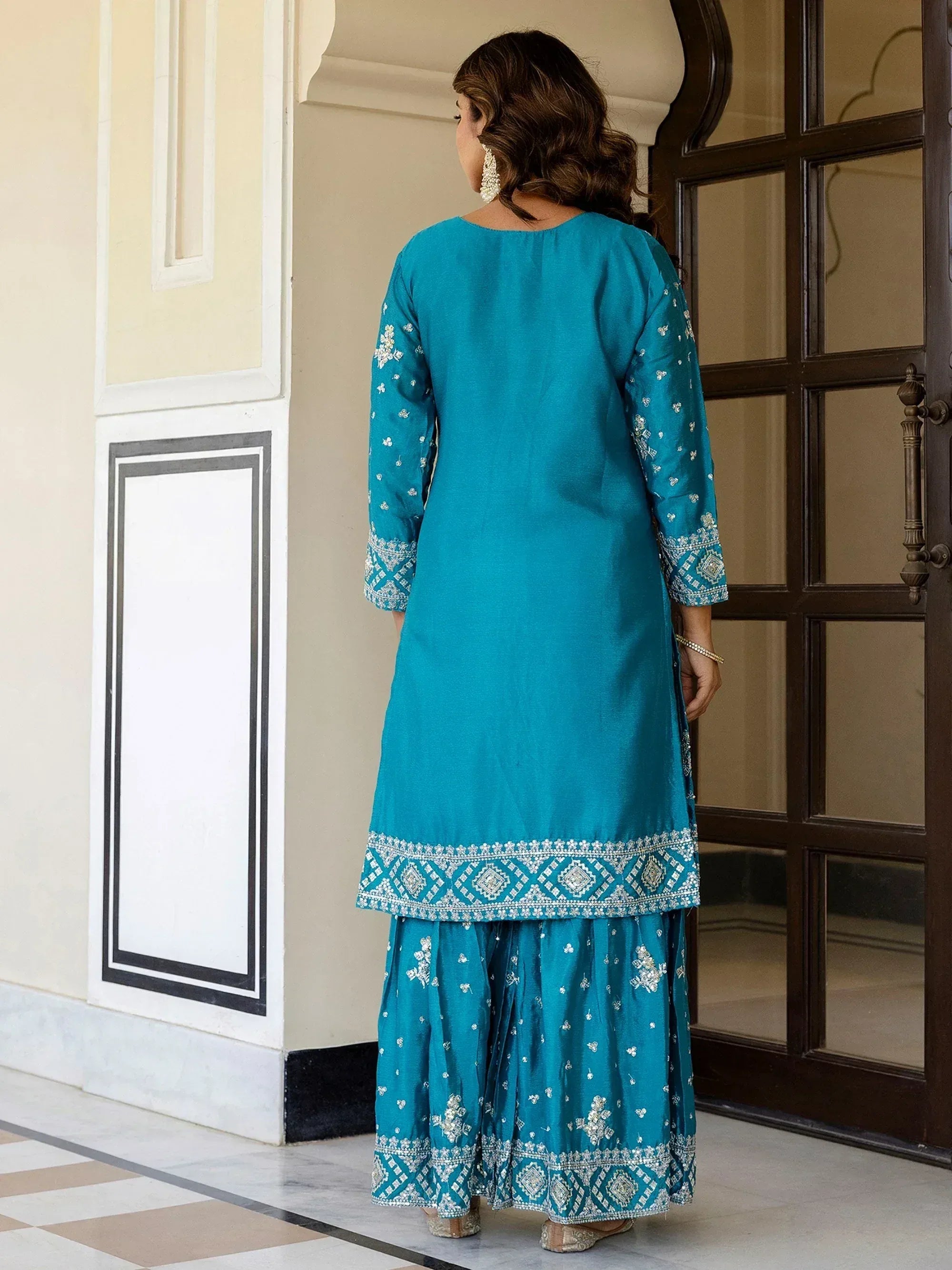 Teal embroidered salwar kameez with intricate detailing, perfect for ethnic occasions