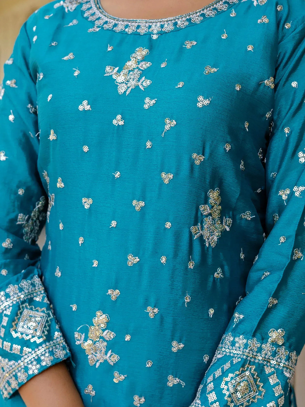 Teal ethnic kurti with floral embroidery and sequin detailing, perfect for Indian wear