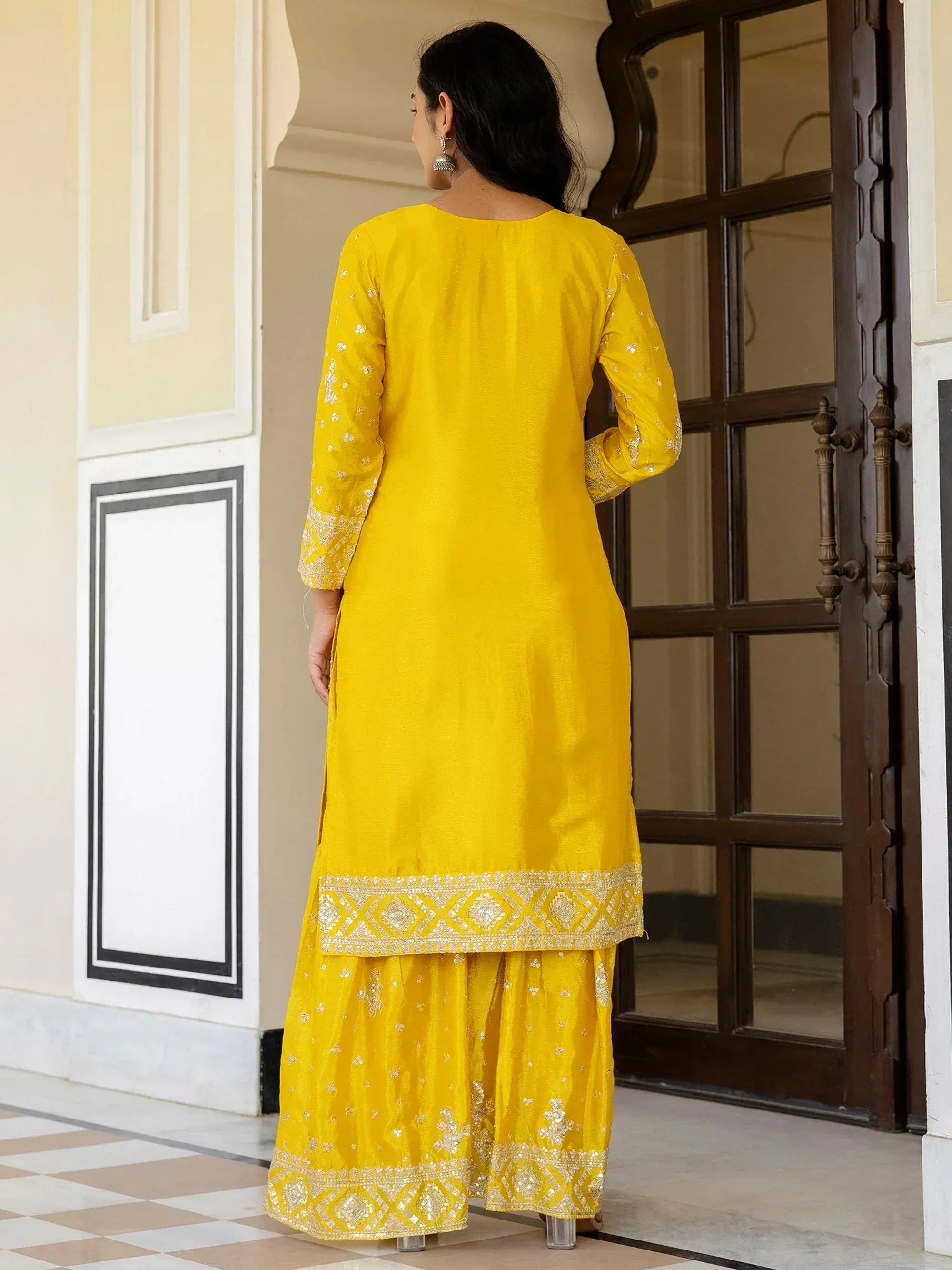 Yellow embroidered salwar kameez with intricate detailing, perfect for ethnic occasions.