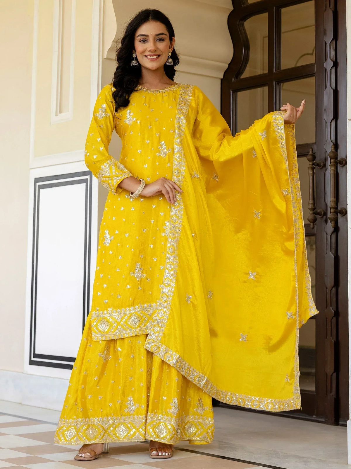 Yellow embroidered salwar kameez with intricate detailing, perfect for ethnic occasions.