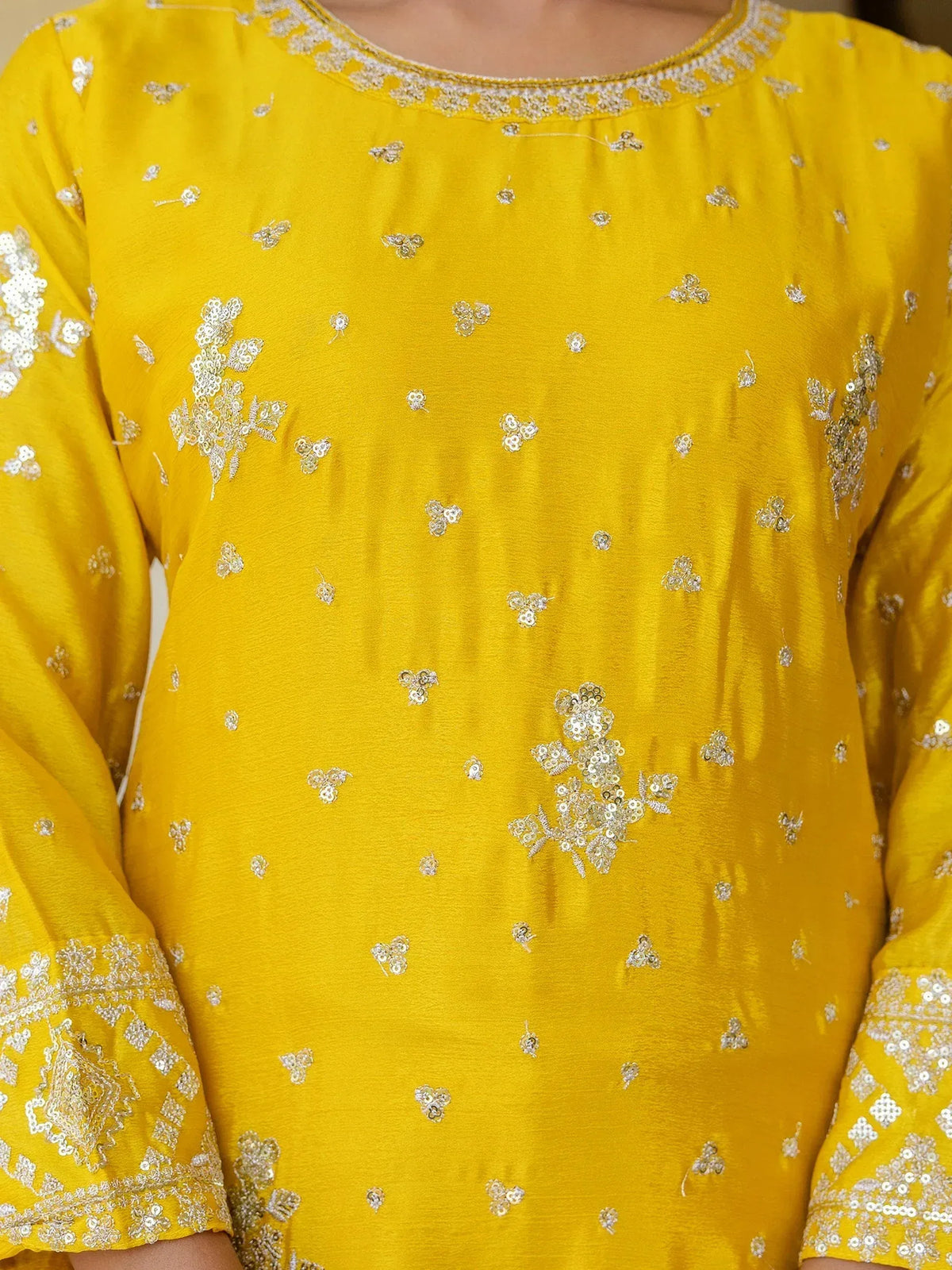 Yellow ethnic kurti with silver floral embroidery and sequin detailing, perfect for festive occasions.