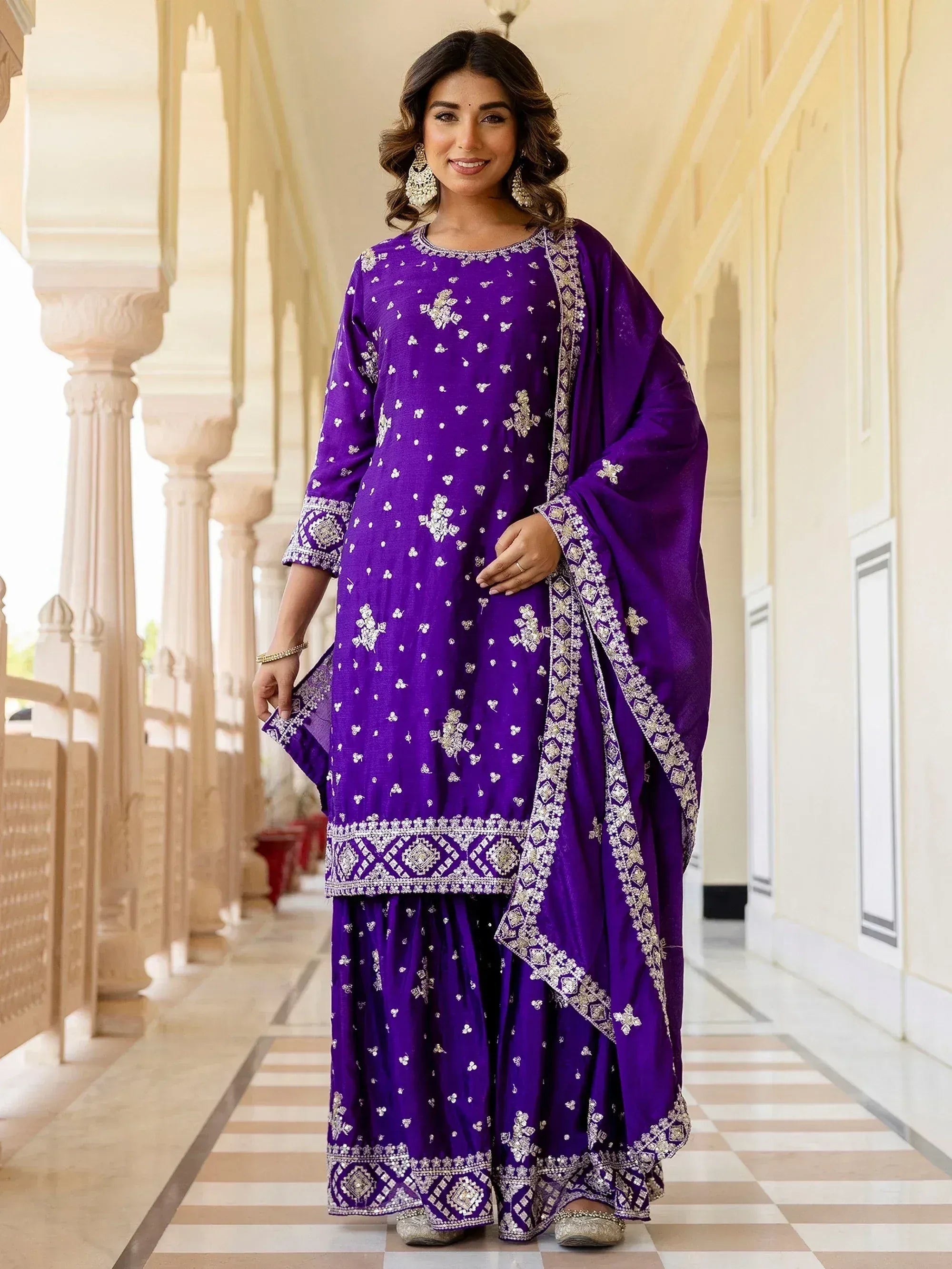 Purple embroidered salwar kameez with gold detailing, perfect for ethnic occasions and festive wear.