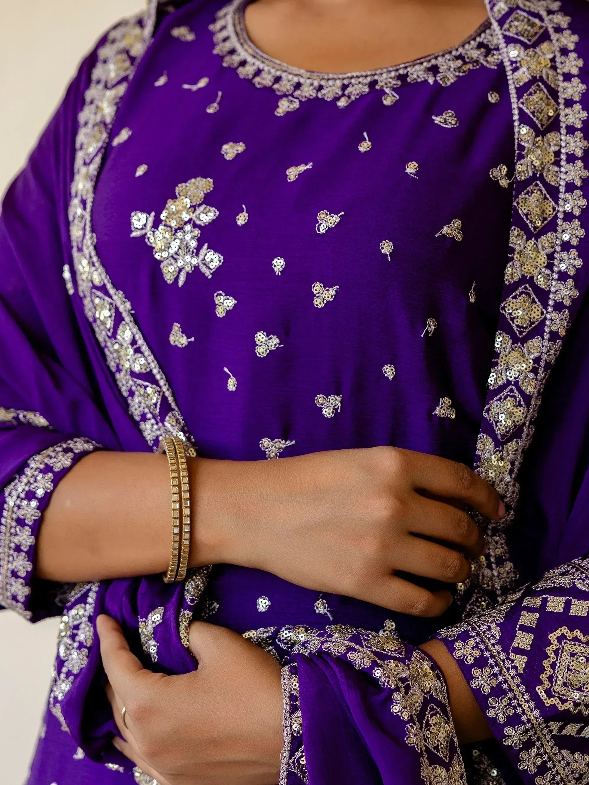 Purple ethnic salwar kameez with intricate gold and silver embroidery, perfect for festive occasions.