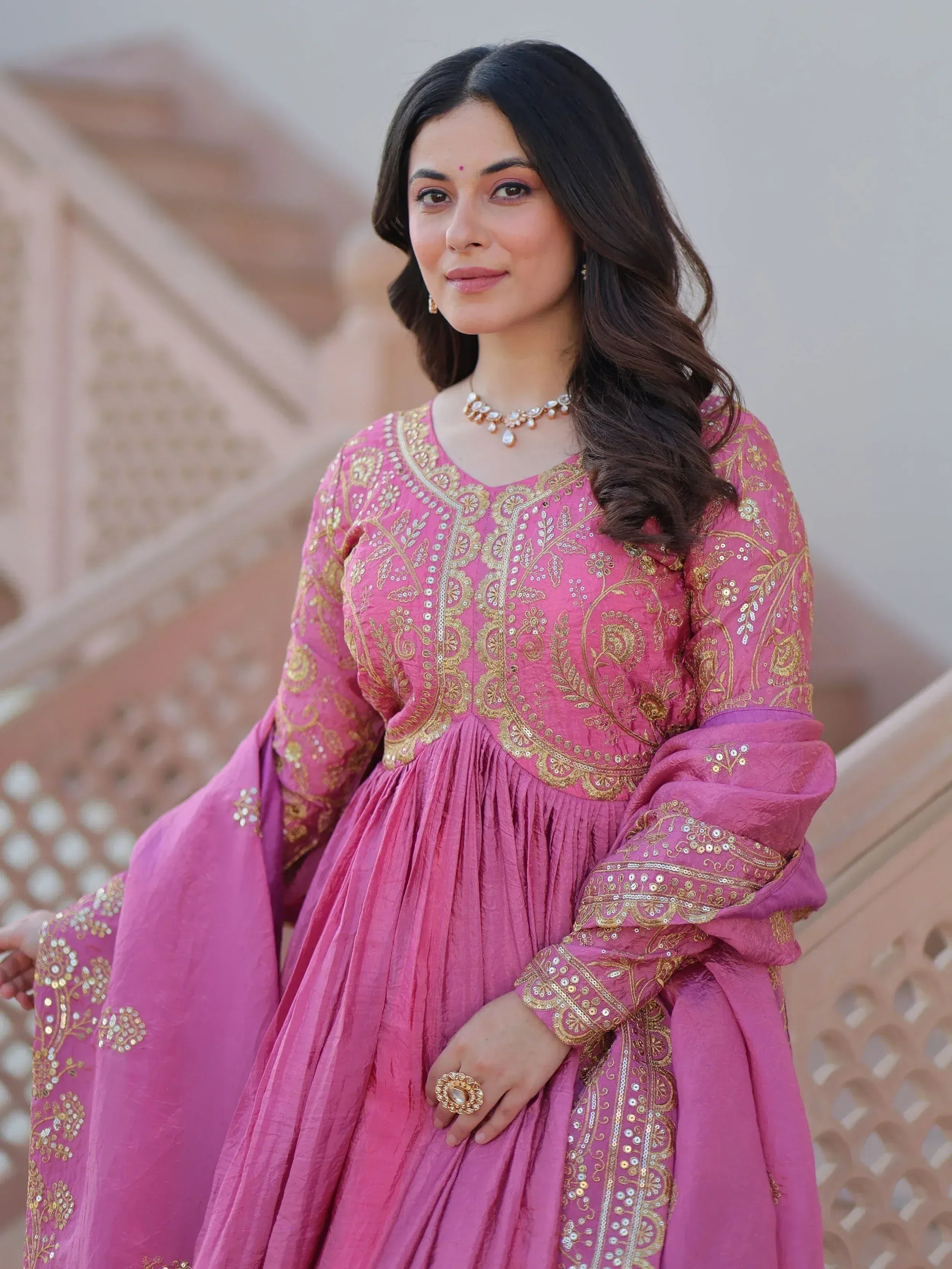 Pink embroidered ethnic gown with gold detailing, perfect for Indian occasions and festive wear.