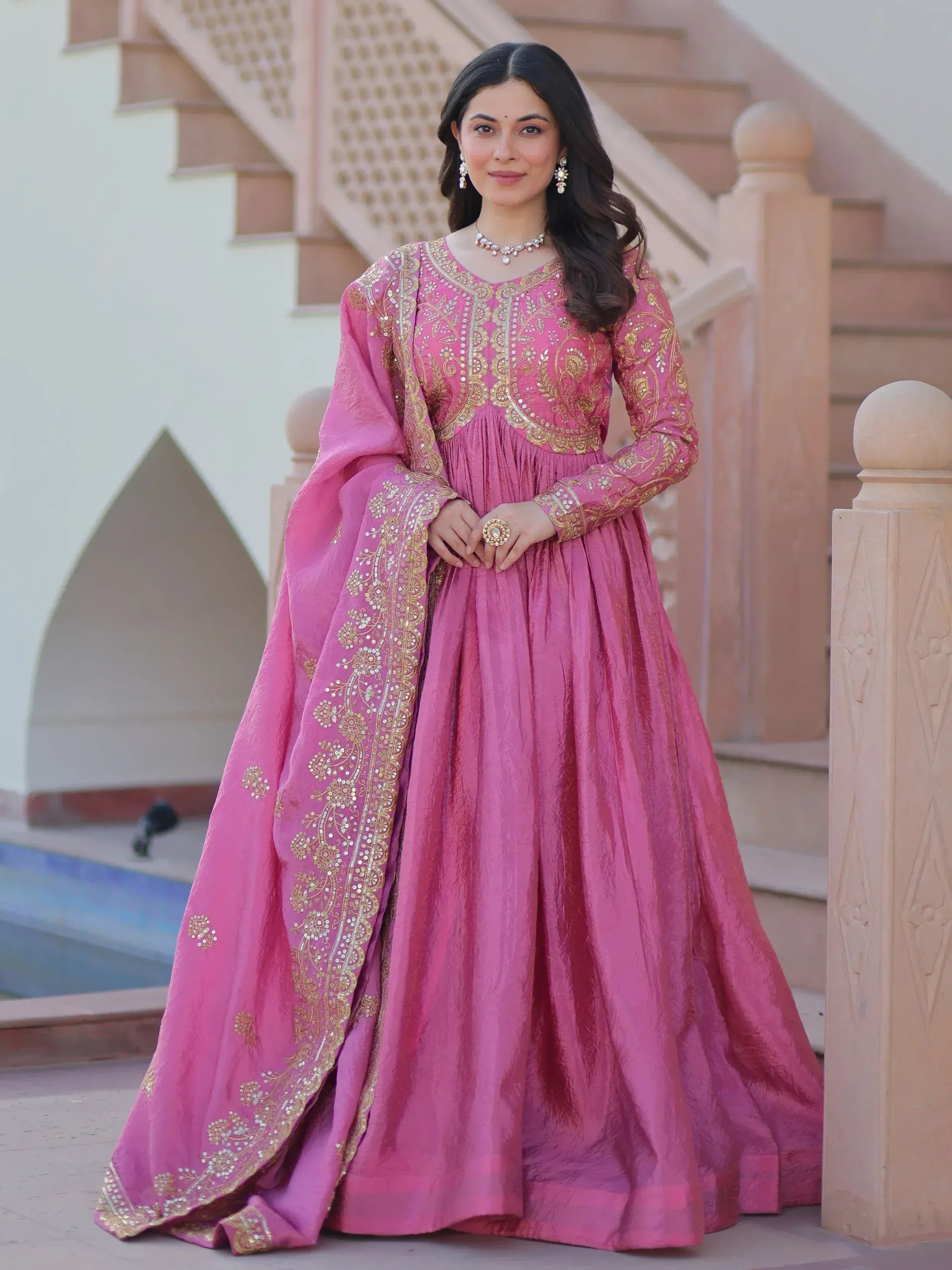 Pink ethnic gown with gold embroidery, perfect for Indian weddings and festive occasions