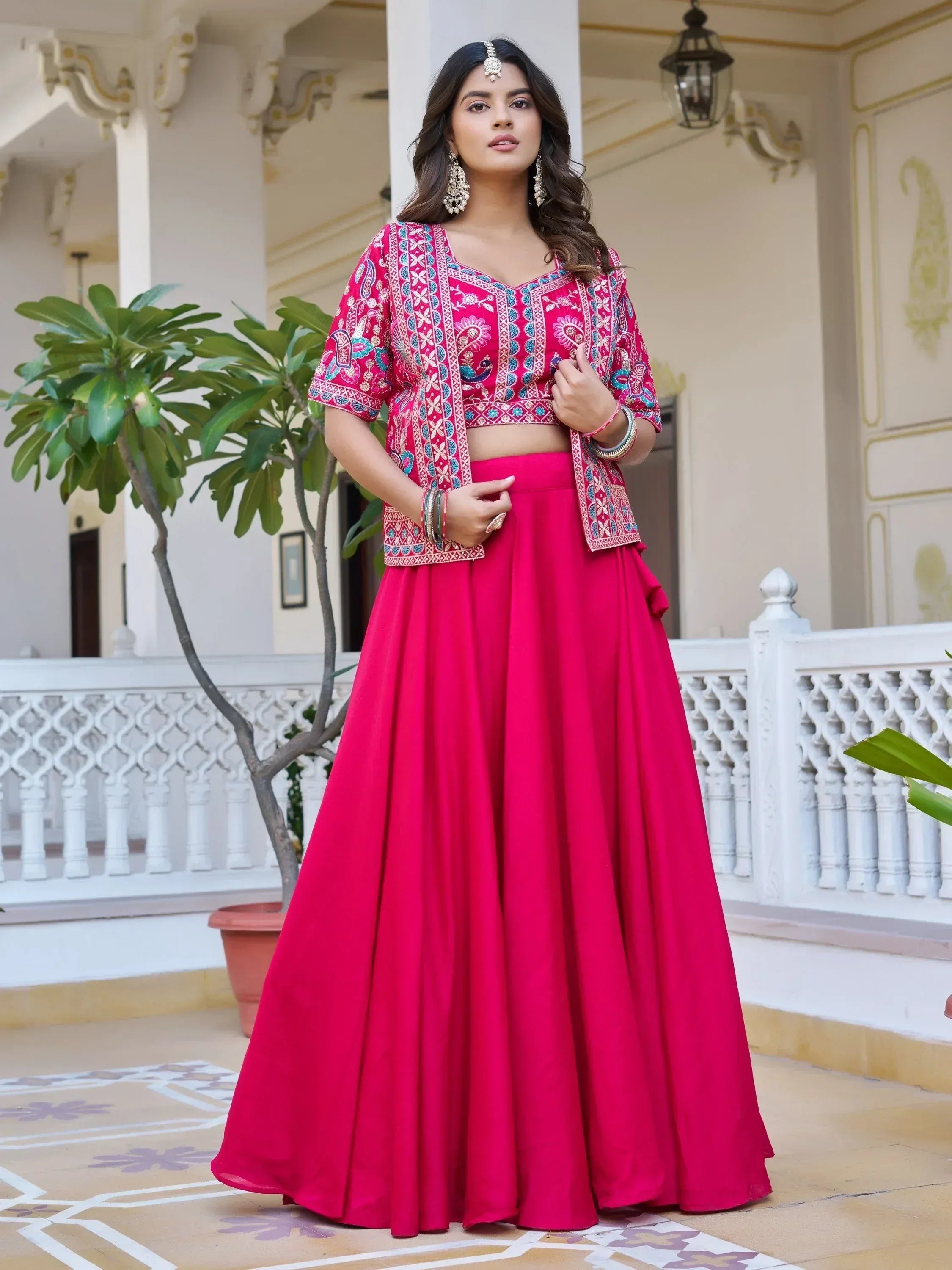 Pink embroidered lehenga choli with floral and peacock motifs, perfect for Indian ethnic wear occasions