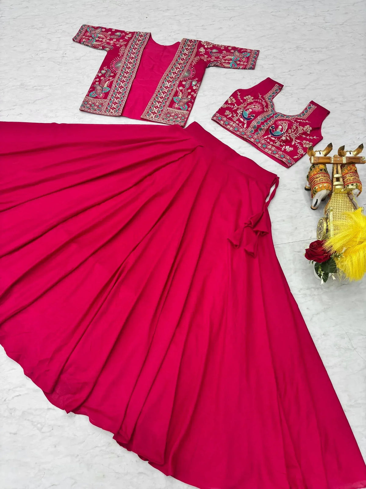Vibrant red ethnic gown with embroidered blouse and dupatta, perfect for Indian celebrations
