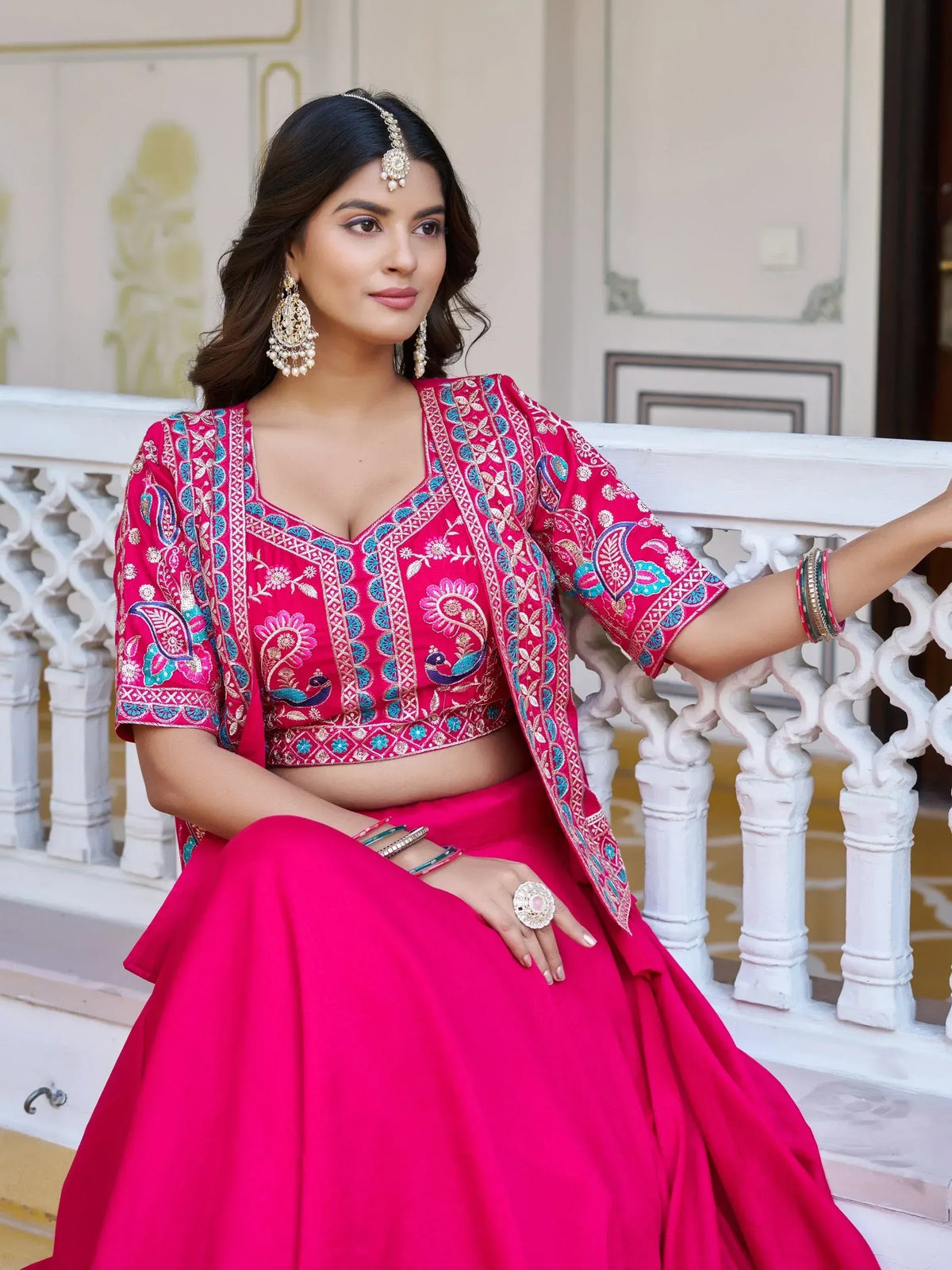 Pink embroidered lehenga choli with peacock motifs, perfect for Indian ethnic wear and festive occasions.