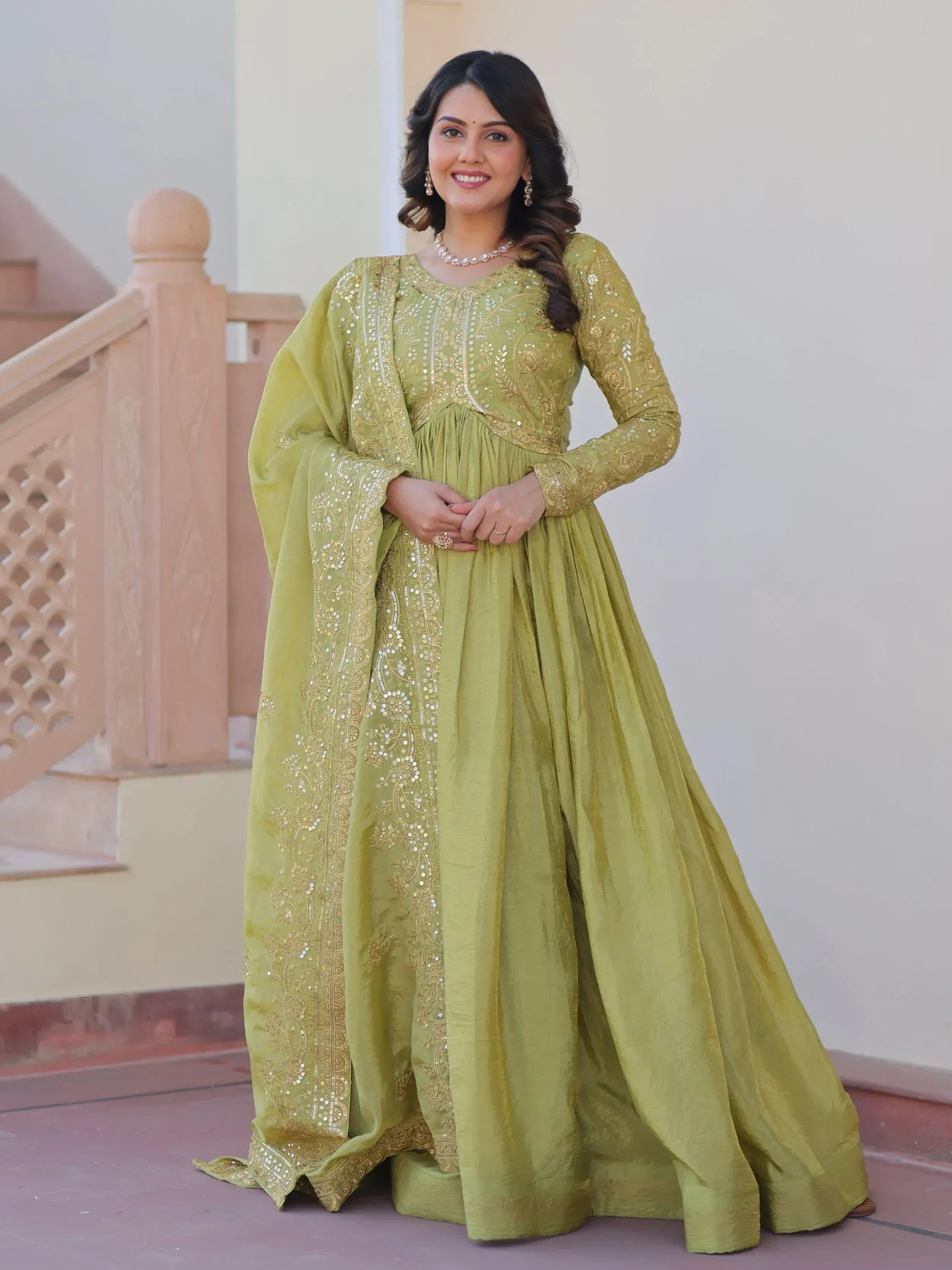 Elegant olive green ethnic gown with gold embroidery and sequins, perfect for Indian occasions