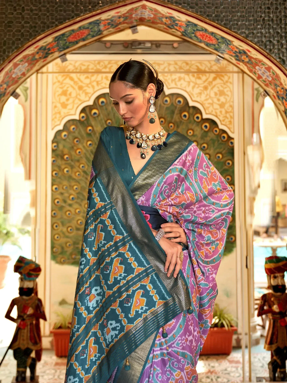 Woman in vibrant ethnic saree with mirror work, traditional jewelry, and marigold decor for festive occasions