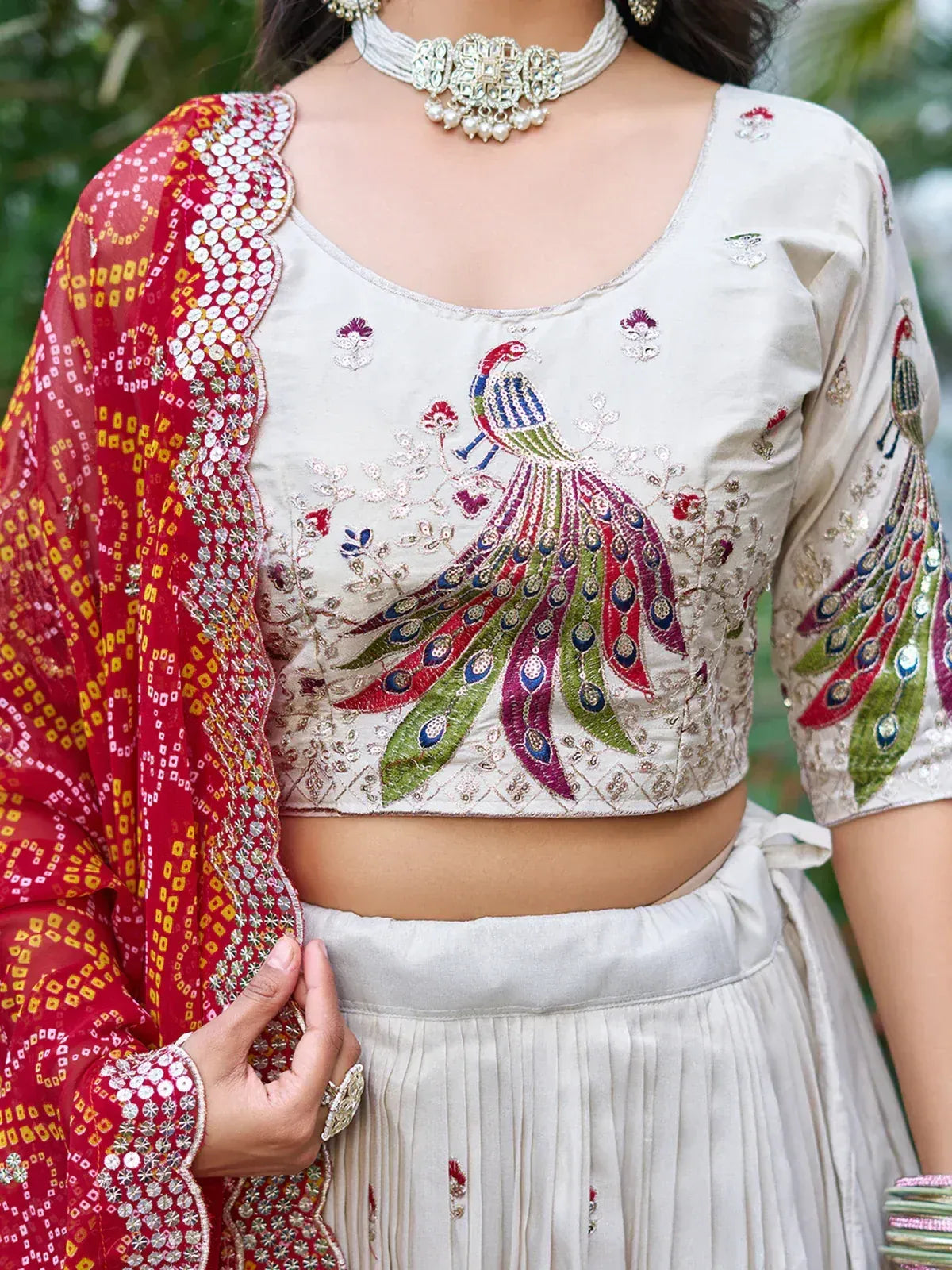 White peacock-embroidered lehenga choli with red dupatta, ethnic Indian wear