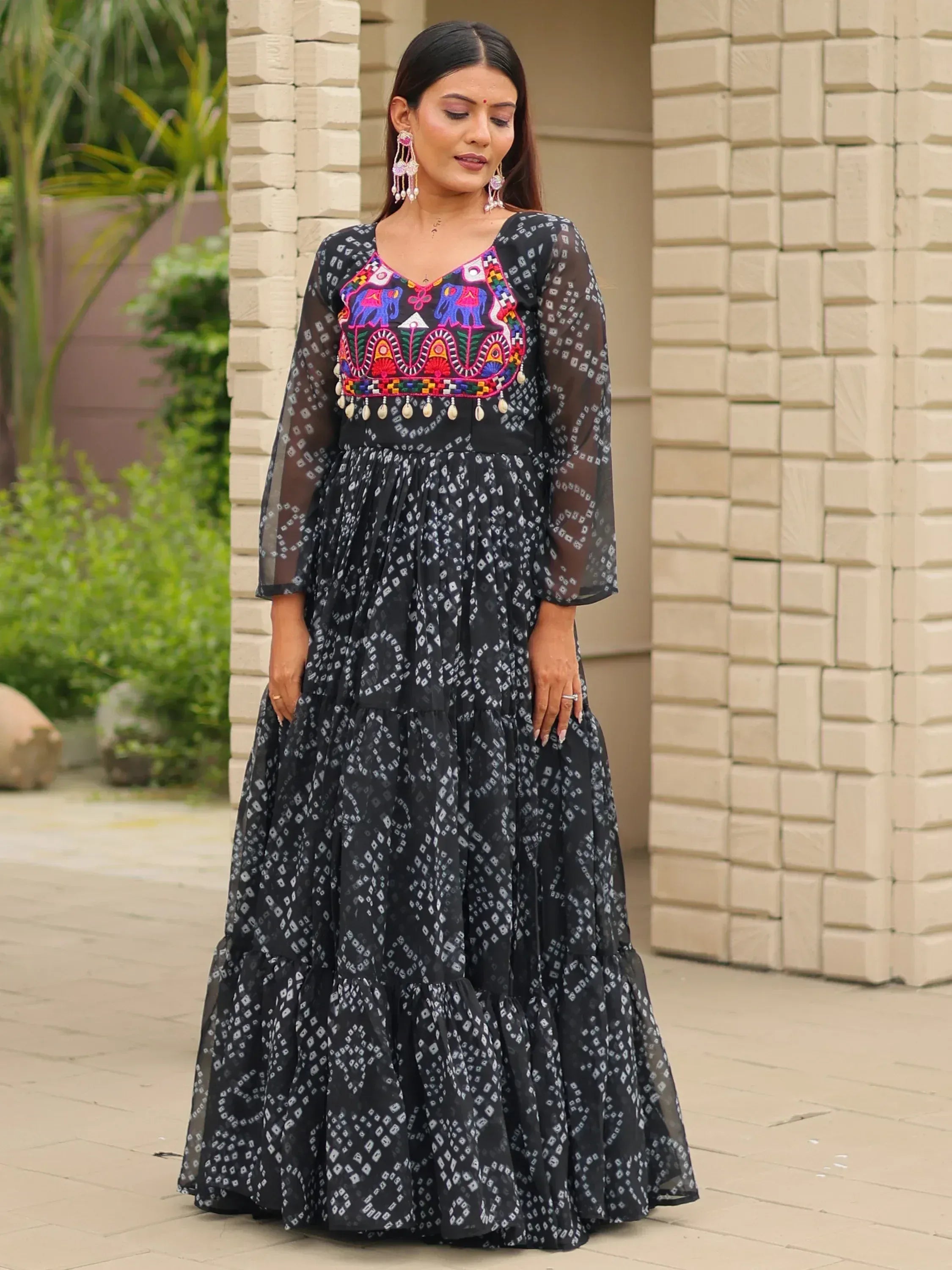 Black ethnic gown with colorful elephant embroidery and sheer sleeves, perfect for Indian occasions