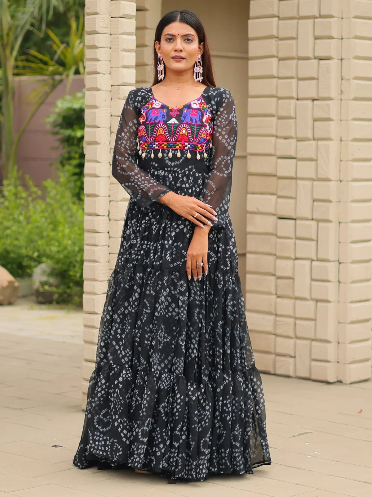 Black ethnic gown with colorful elephant embroidery and sheer sleeves, perfect for Indian festive wear.