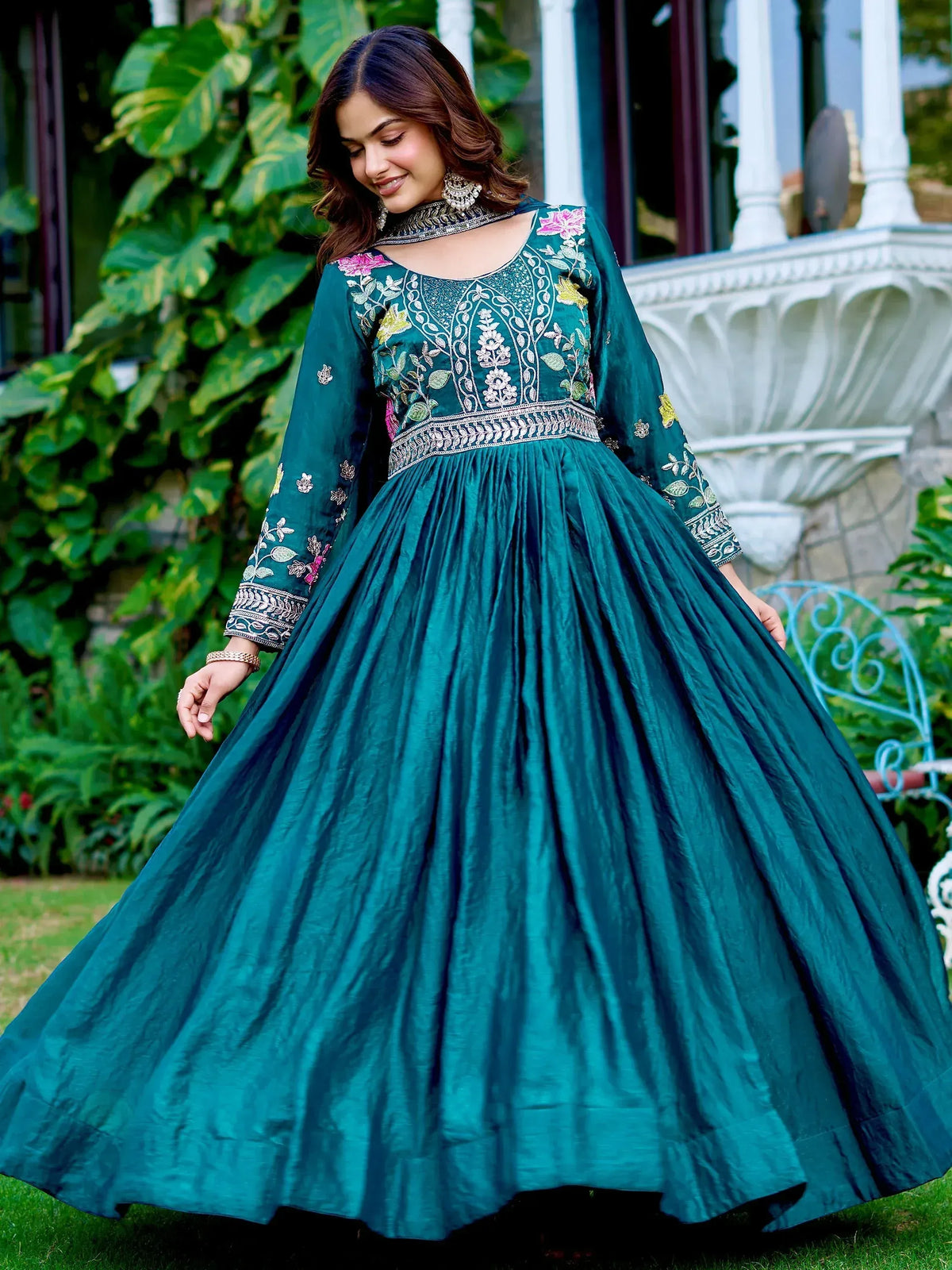 Teal embroidered ethnic gown with floral detailing, perfect for Indian celebrations and festive occasions.