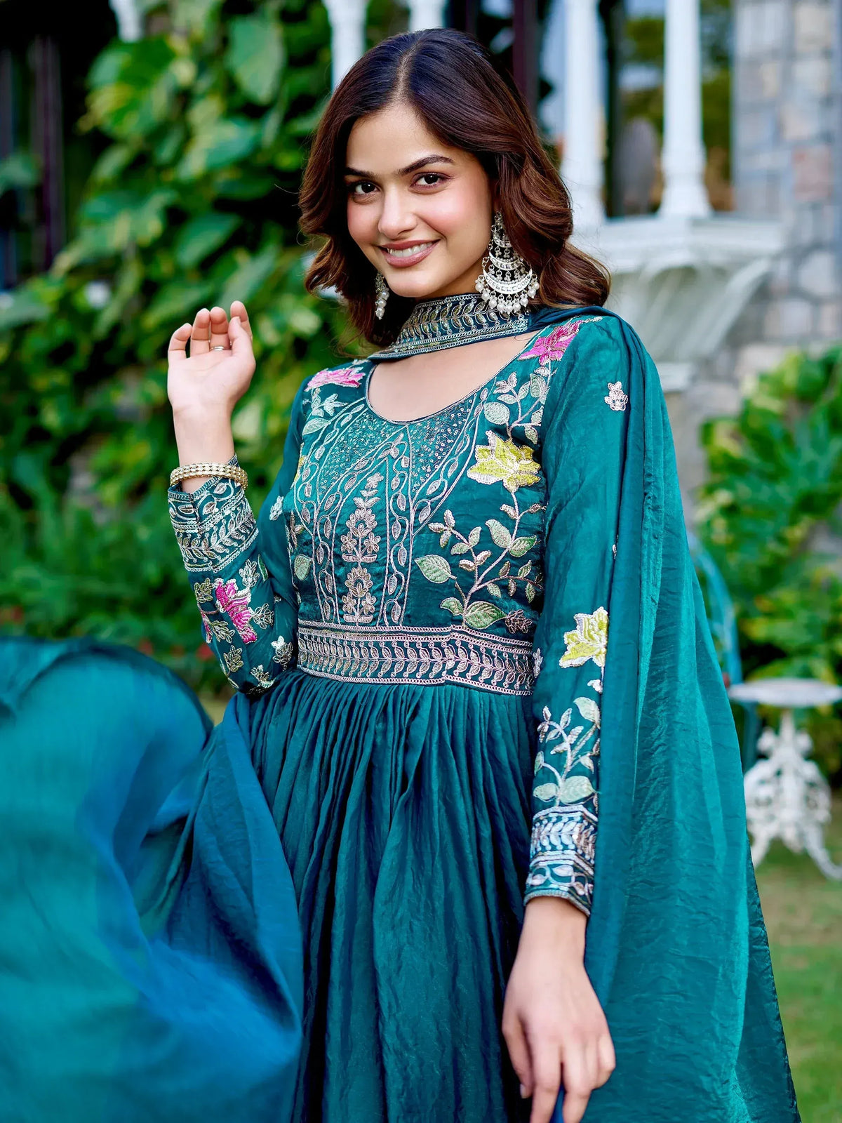 Teal embroidered ethnic gown with floral motifs, perfect for Indian occasions and festive wear.