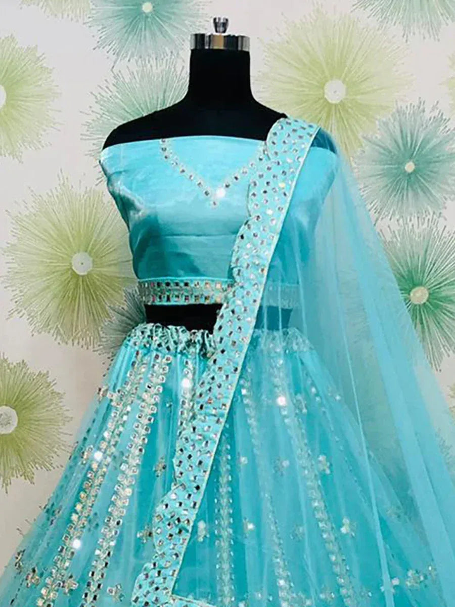 Turquoise designer lehenga choli with mirror work and sheer dupatta, perfect for Indian ethnic occasions
