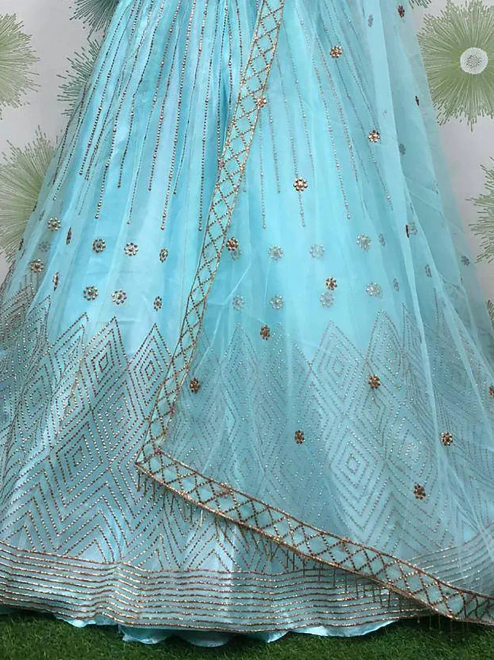 Light blue designer lehenga with intricate gold embroidery and beadwork, perfect for ethnic occasions