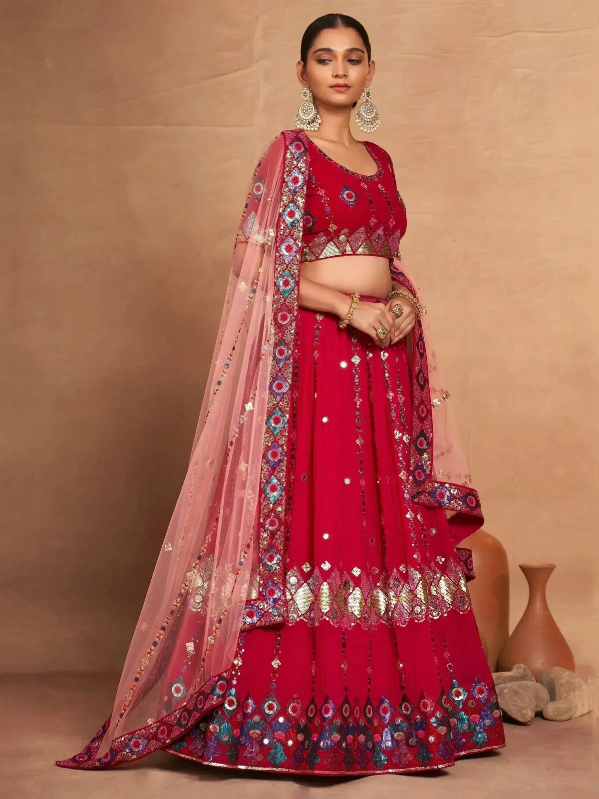 Red embroidered lehenga choli with pink dupatta, perfect for Indian weddings and festive occasions.