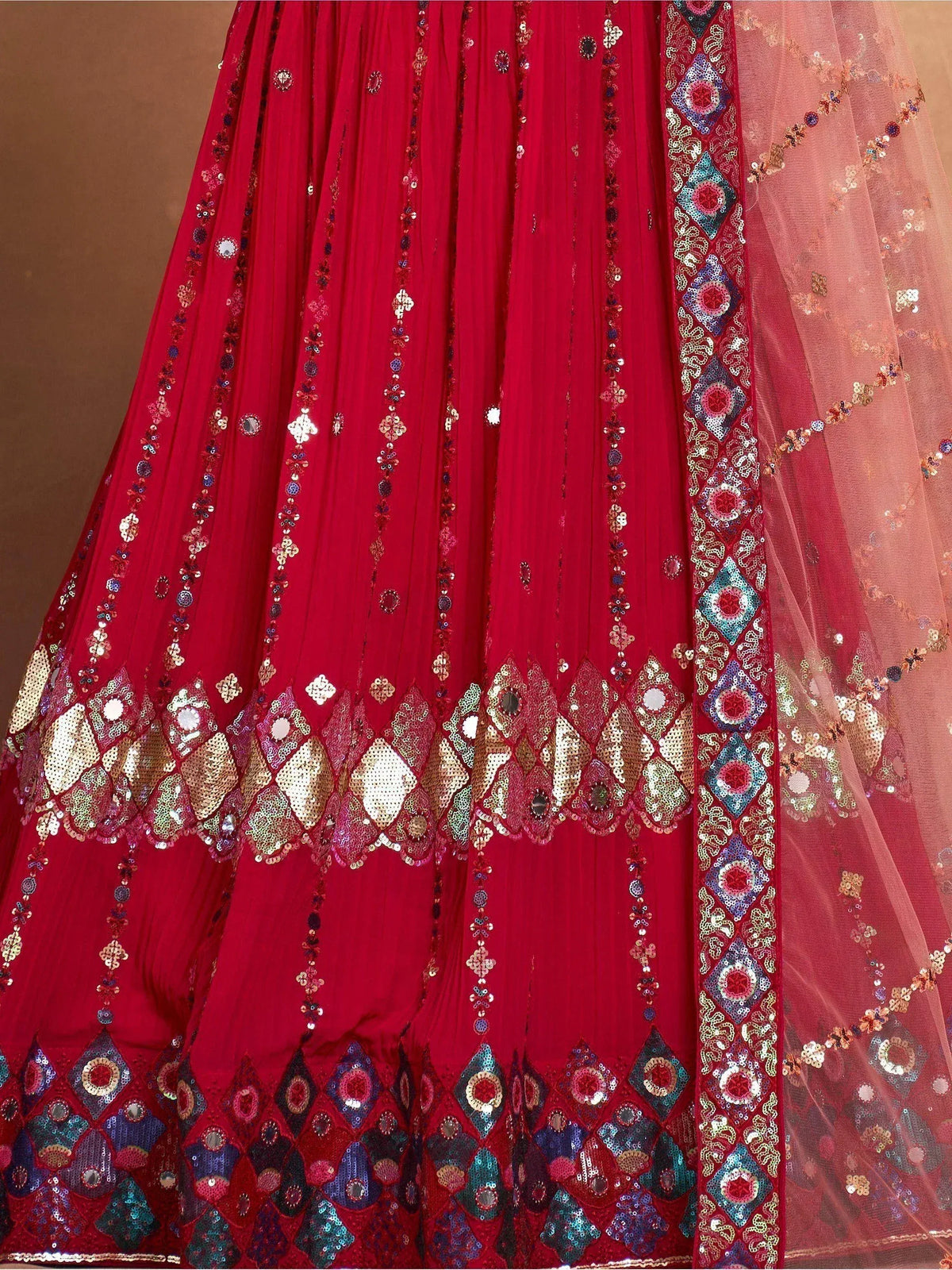 Red lehenga choli with intricate sequin and mirror work, perfect for Indian ethnic wear
