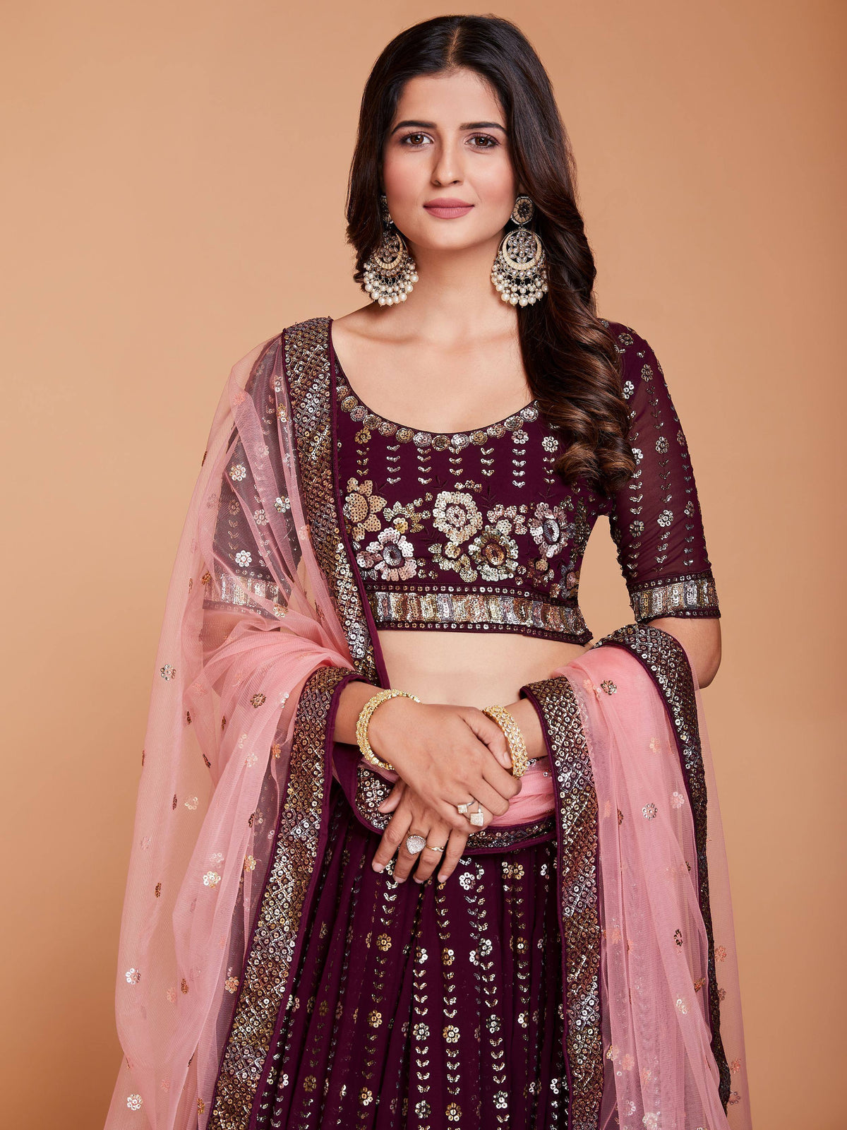 Elegant maroon lehenga choli with gold embroidery and pink dupatta, perfect for Indian ethnic wear