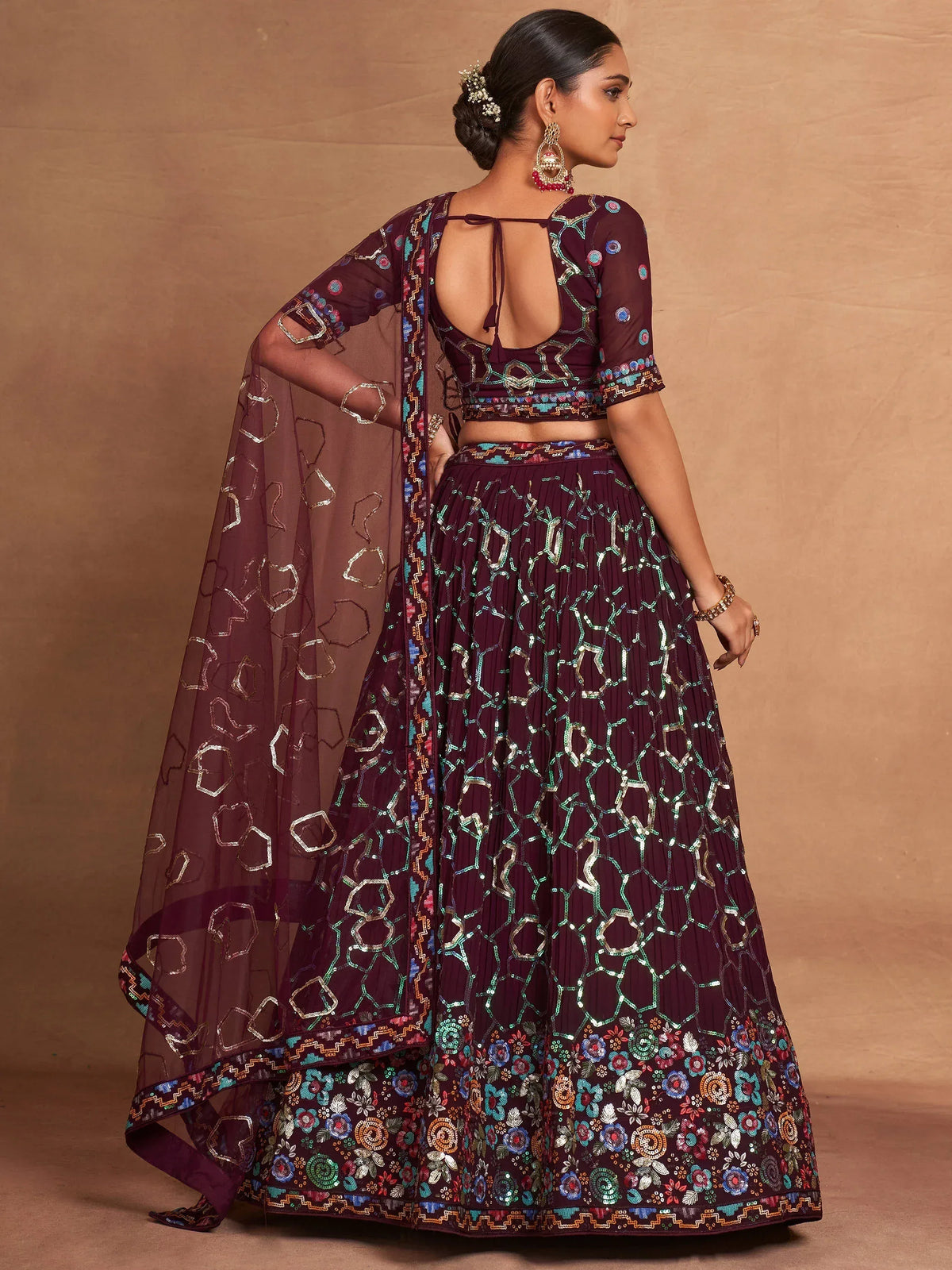 Elegant maroon lehenga choli with geometric and floral embroidery, perfect for Indian ethnic wear.