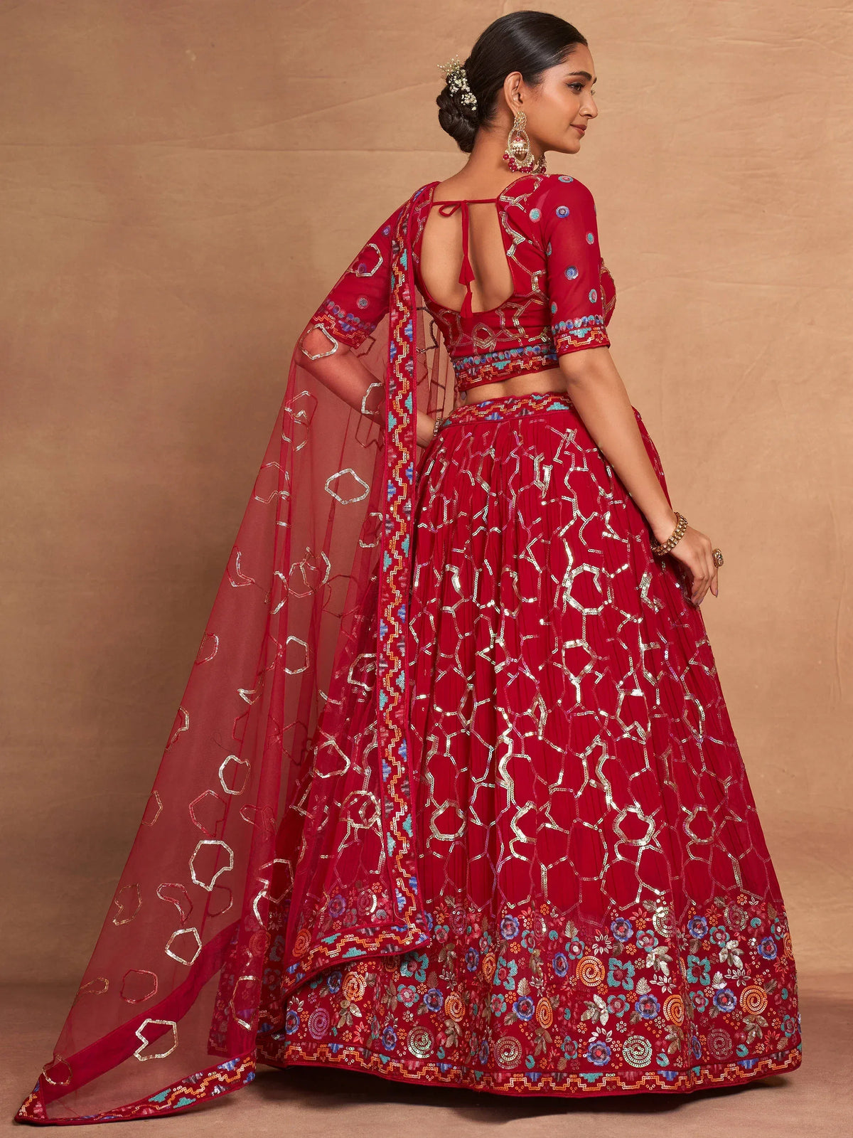 Red embroidered lehenga choli with floral patterns and sheer dupatta for Indian ethnic wear