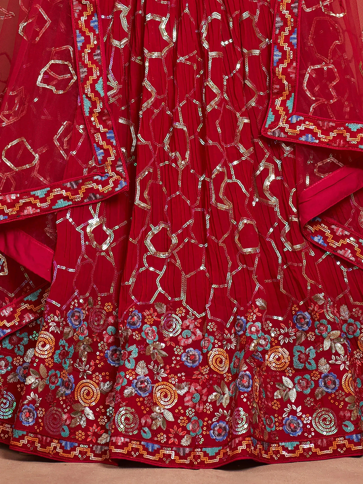 Red embroidered lehenga with floral and geometric patterns, perfect for ethnic wear.
