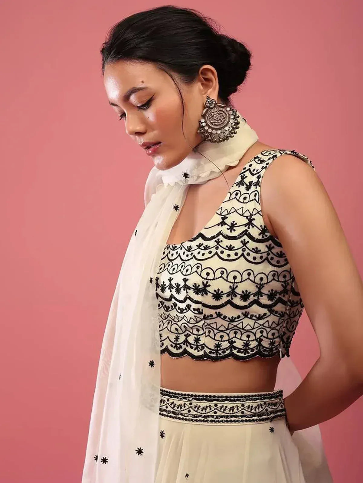 White and black embroidered lehenga choli with sheer dupatta and statement earrings