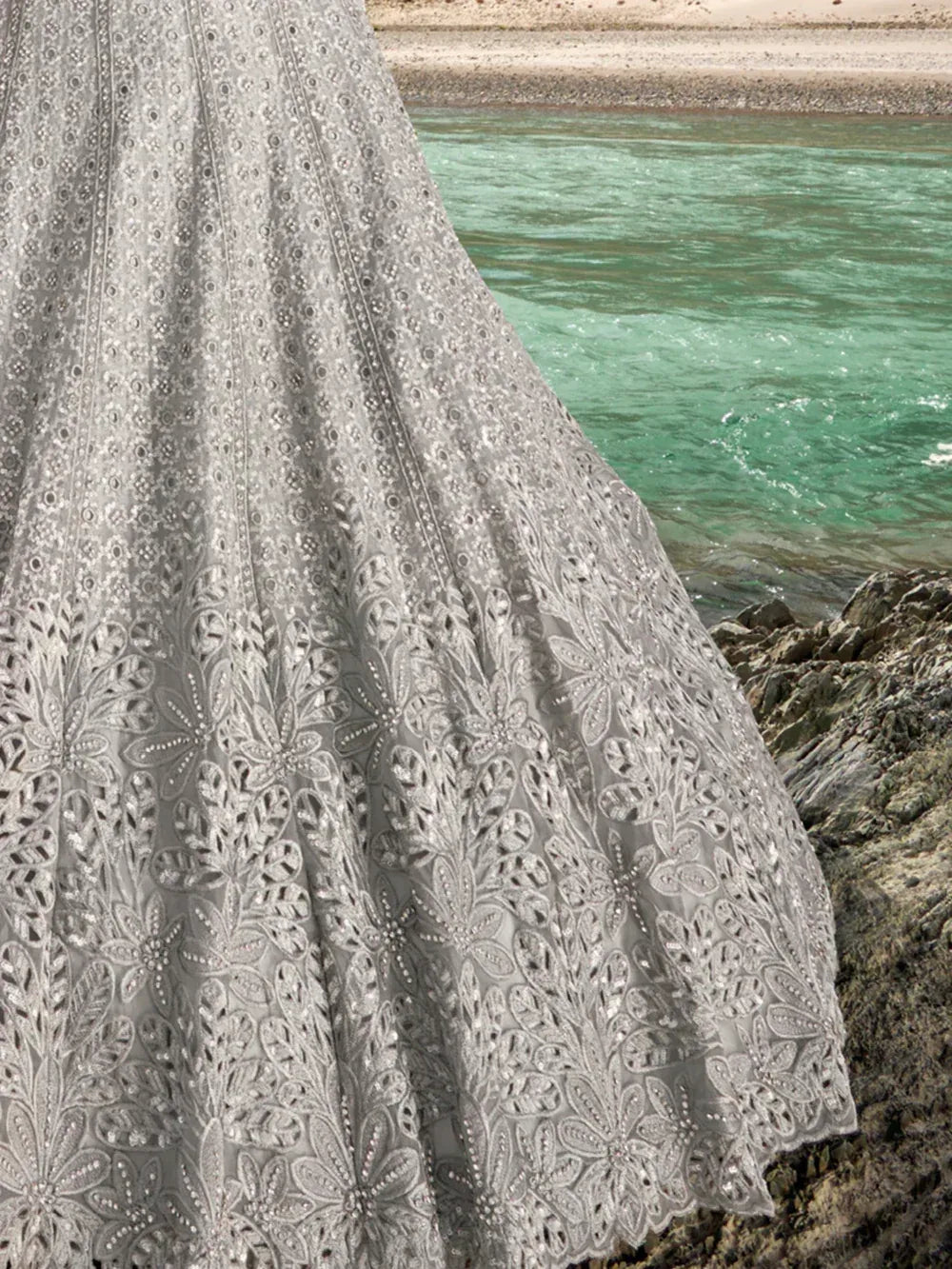 Elegant grey embroidered lehenga with floral patterns near a riverbank